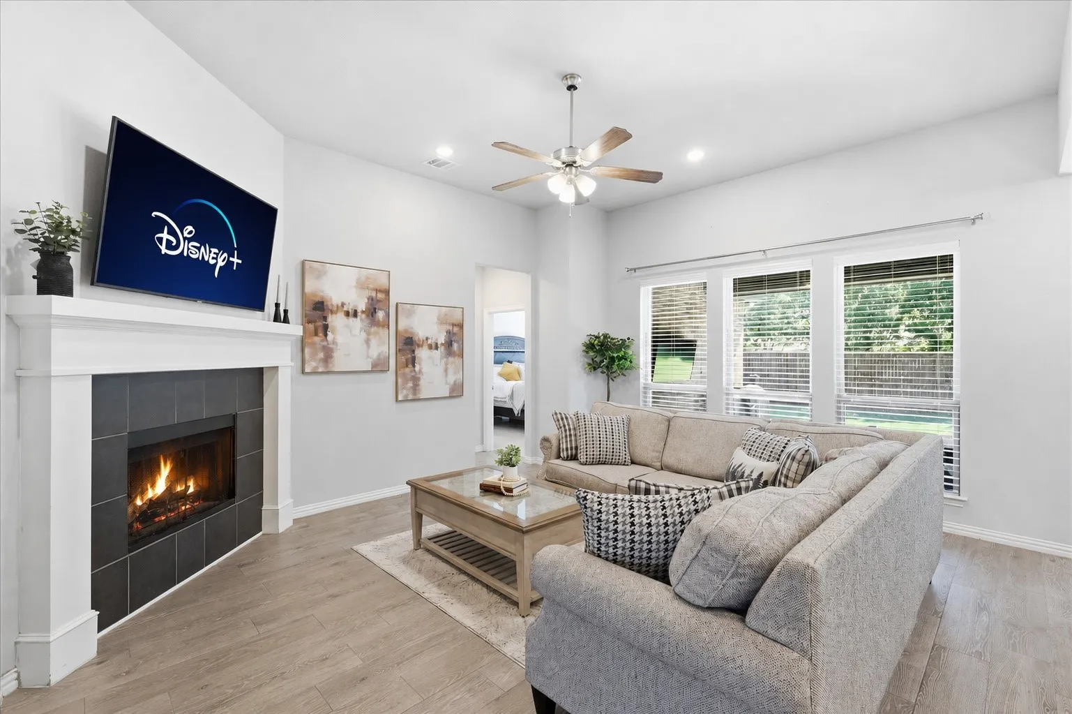 Gorgeous living room with natural light, gas fireplace, open concept to kitchen and dining and plenty of room for entertaining!