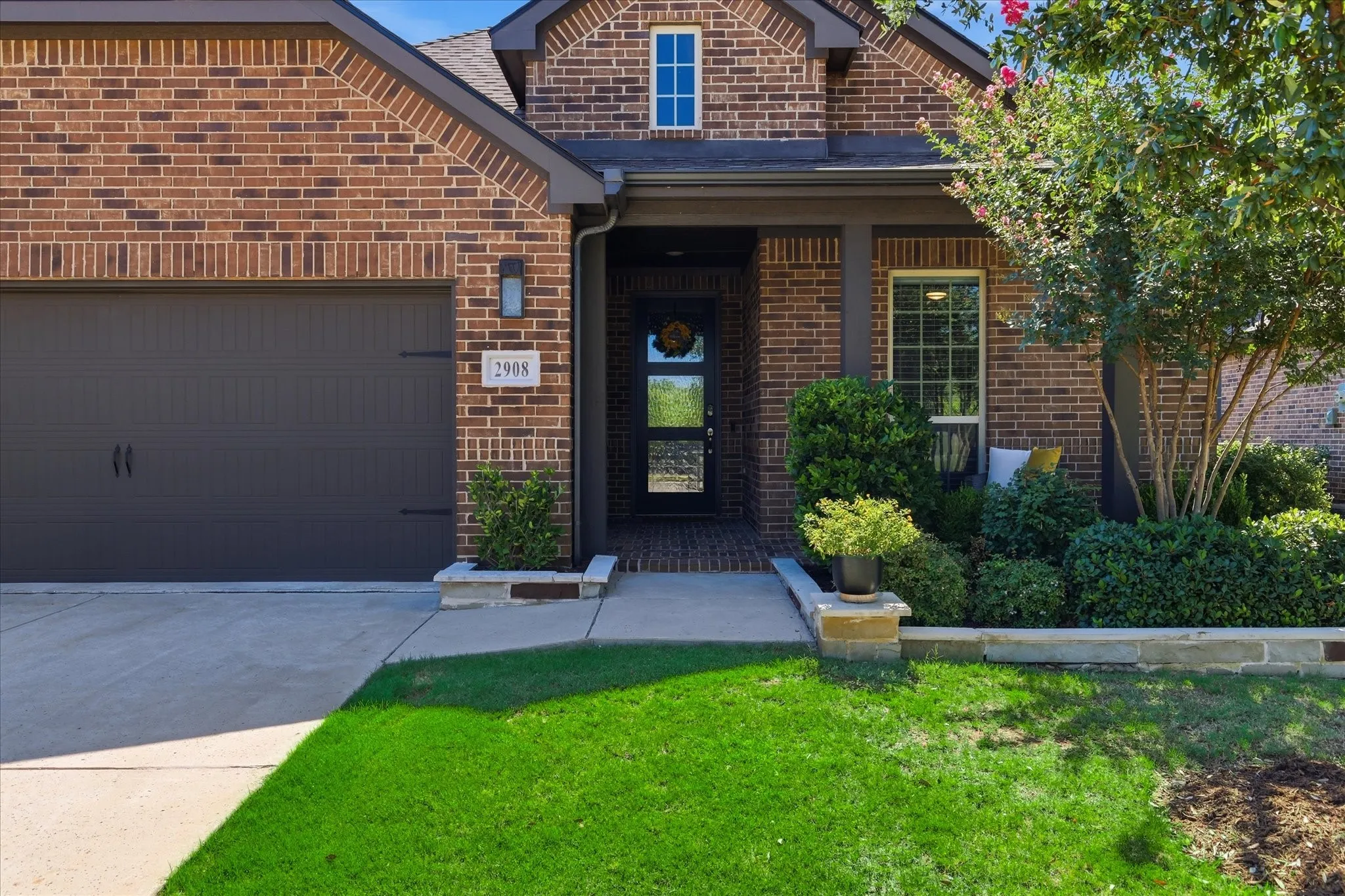Gorgeous landscaped front view of home with patio to enjoy the private cul-de-sac.