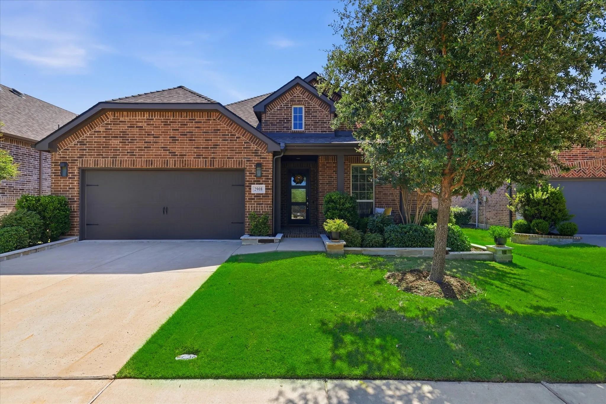 Gorgeous landscaped front view of home with patio to enjoy the private cul-de-sac.