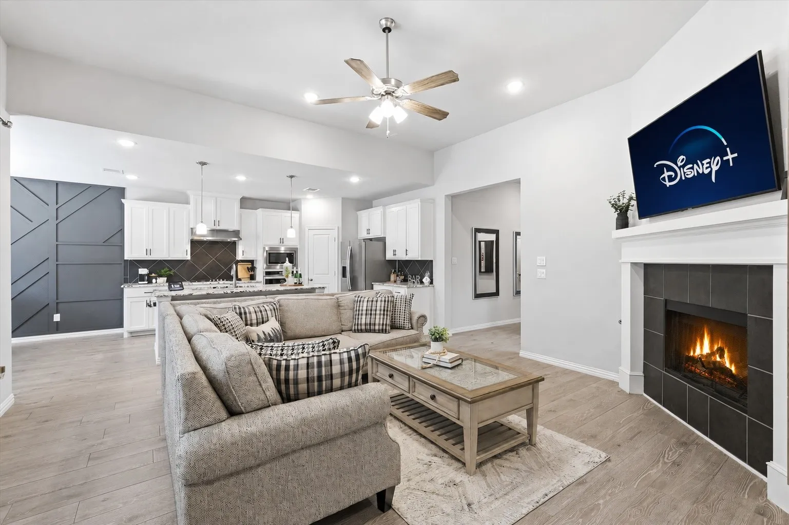 Gorgeous living room with natural light, gas fireplace, open concept to kitchen and dining and plenty of room for entertaining!