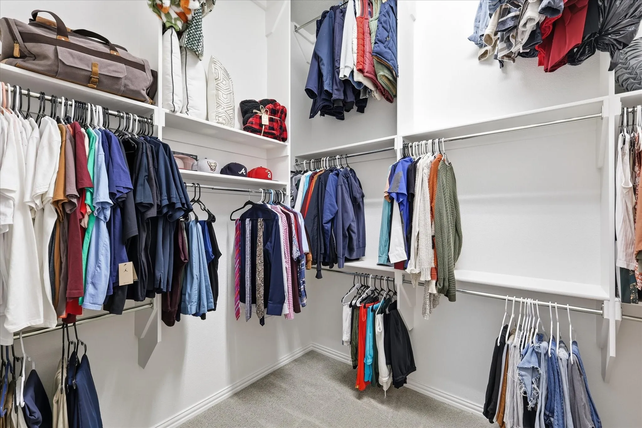 Large primary closet with massive amount of storage