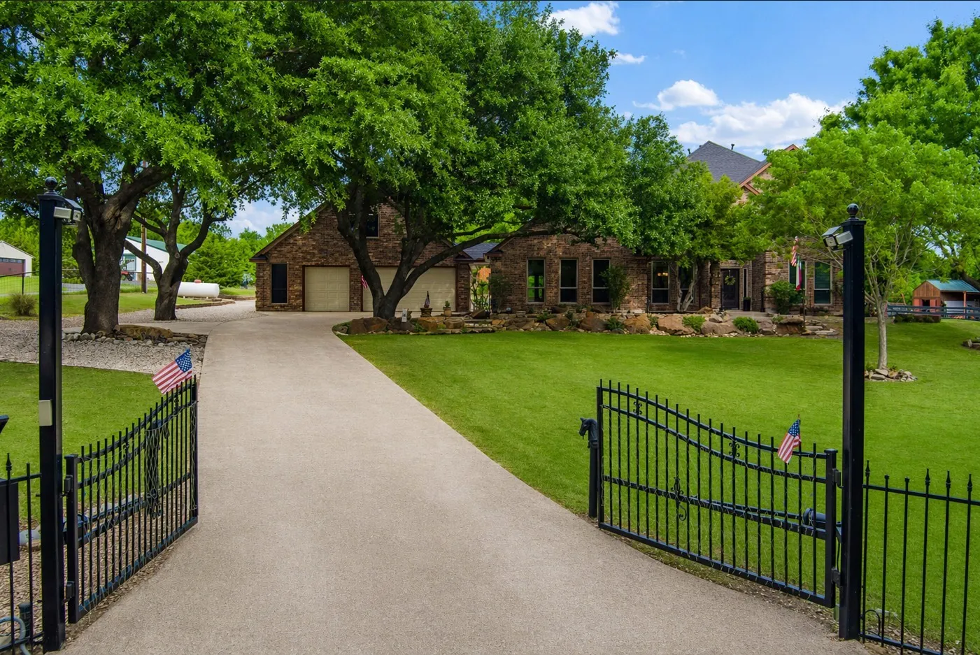 Welcome to 1820 Winningkoff Dr., a gorgeous estate featuring a private gated entrance, mature trees, and a long drive leading to a serene, retreat-like setting.