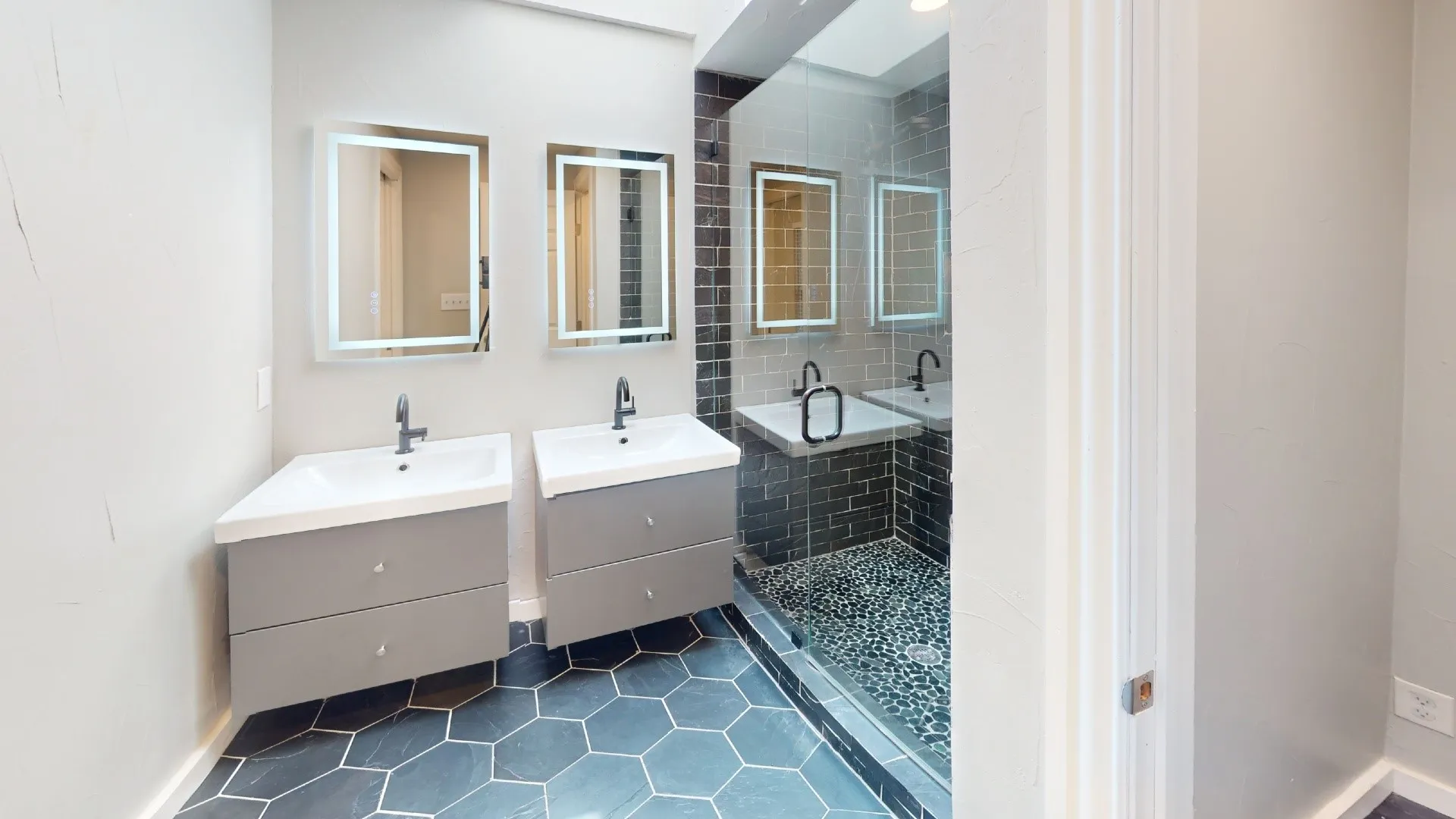 Dual floating vanities featuring integrated sinks and matte black fixtures