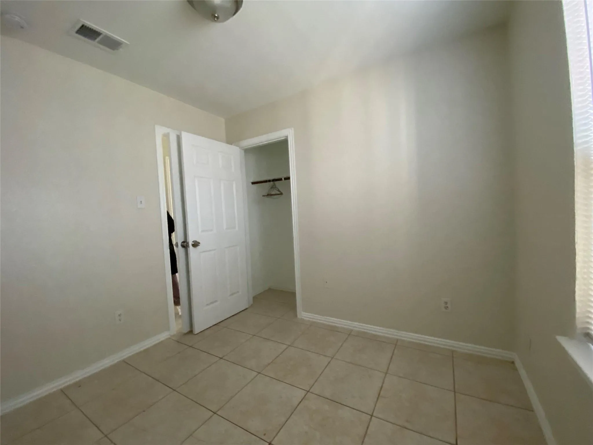 Unfurnished bedroom featuring light tile patterned flooring