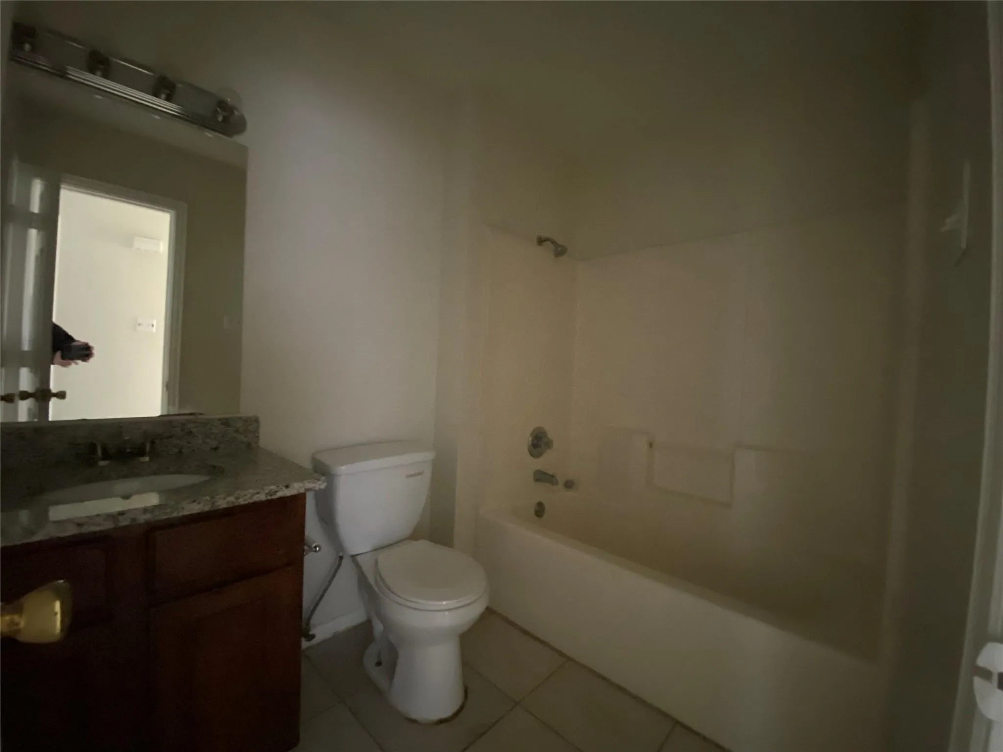Full bathroom with tile patterned floors, vanity, shower / bathing tub combination, and toilet