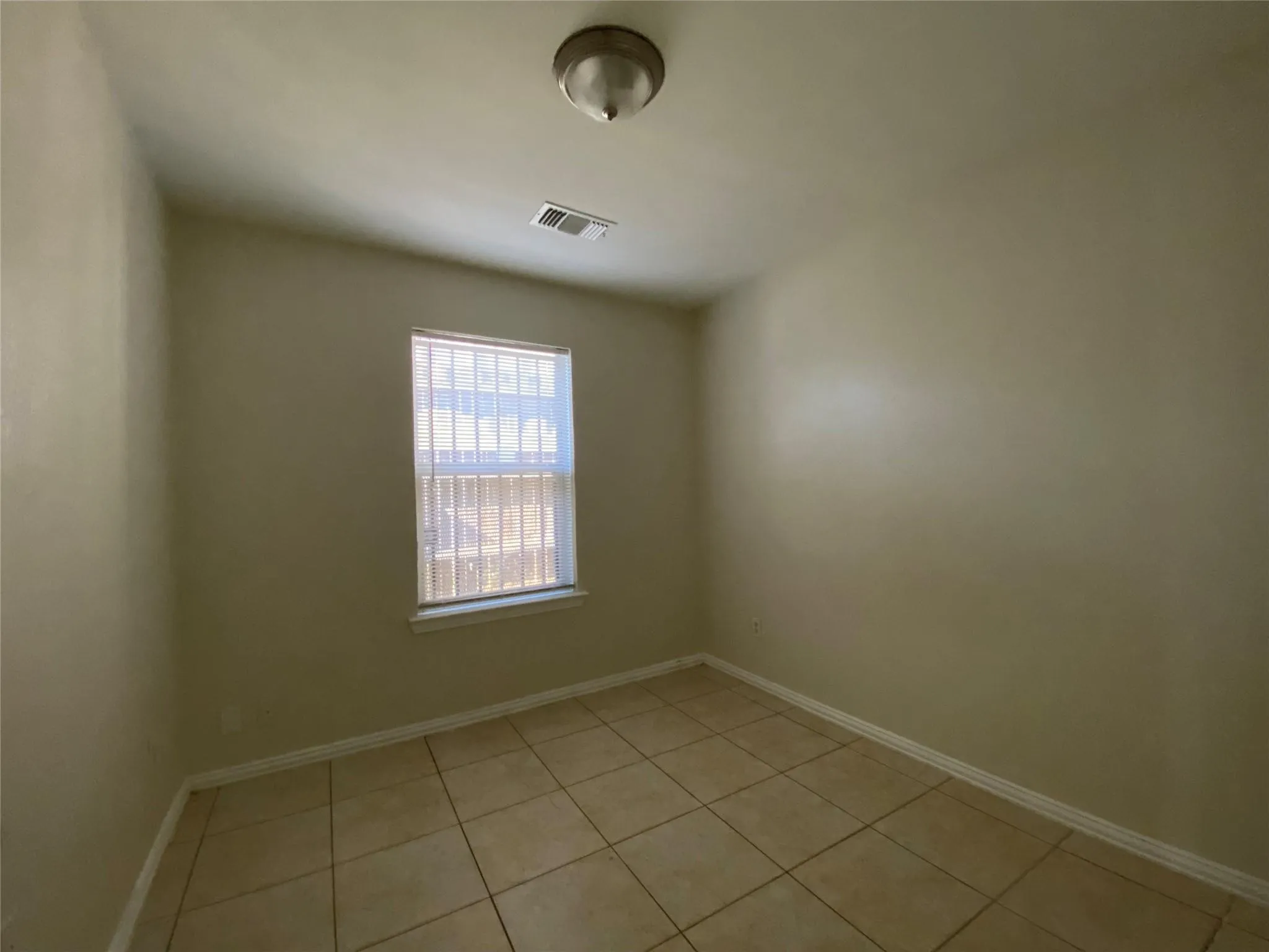 View of tiled spare room