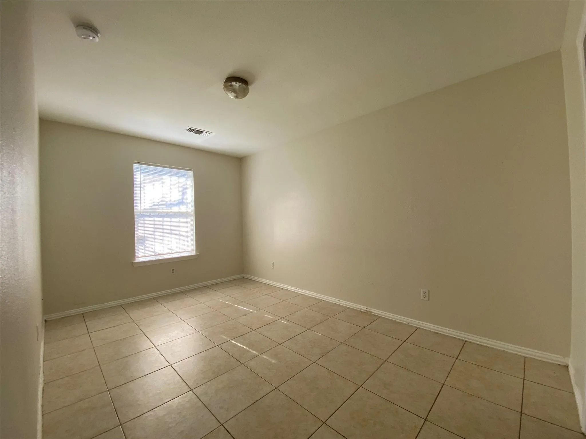 Empty room with light tile patterned floors