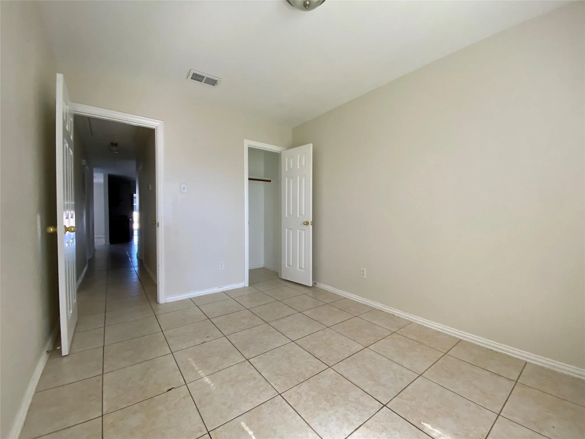 Unfurnished bedroom with light tile patterned flooring