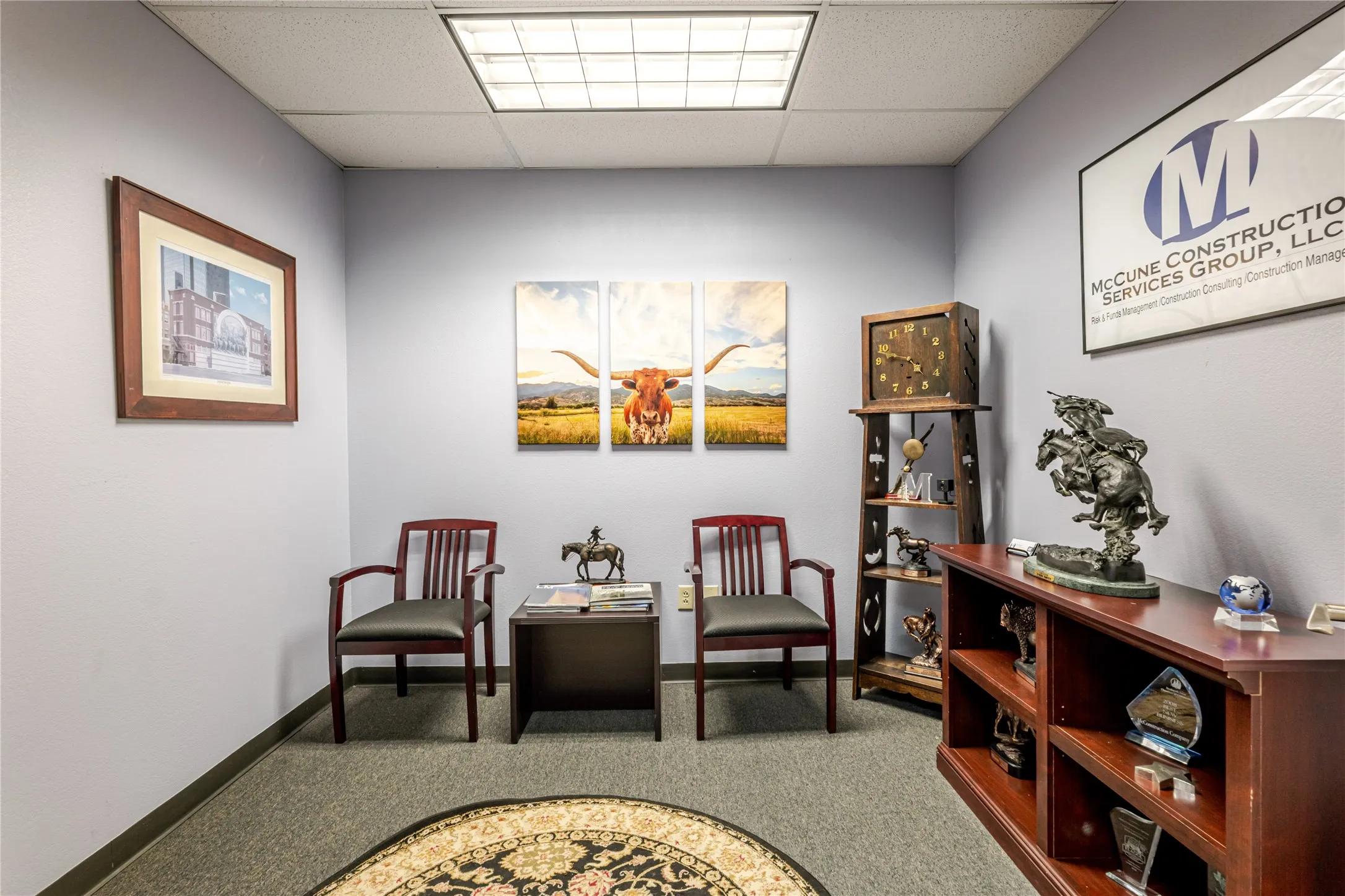 Neutral-toned carpeting paired with light blue walls and a white acoustical ceiling