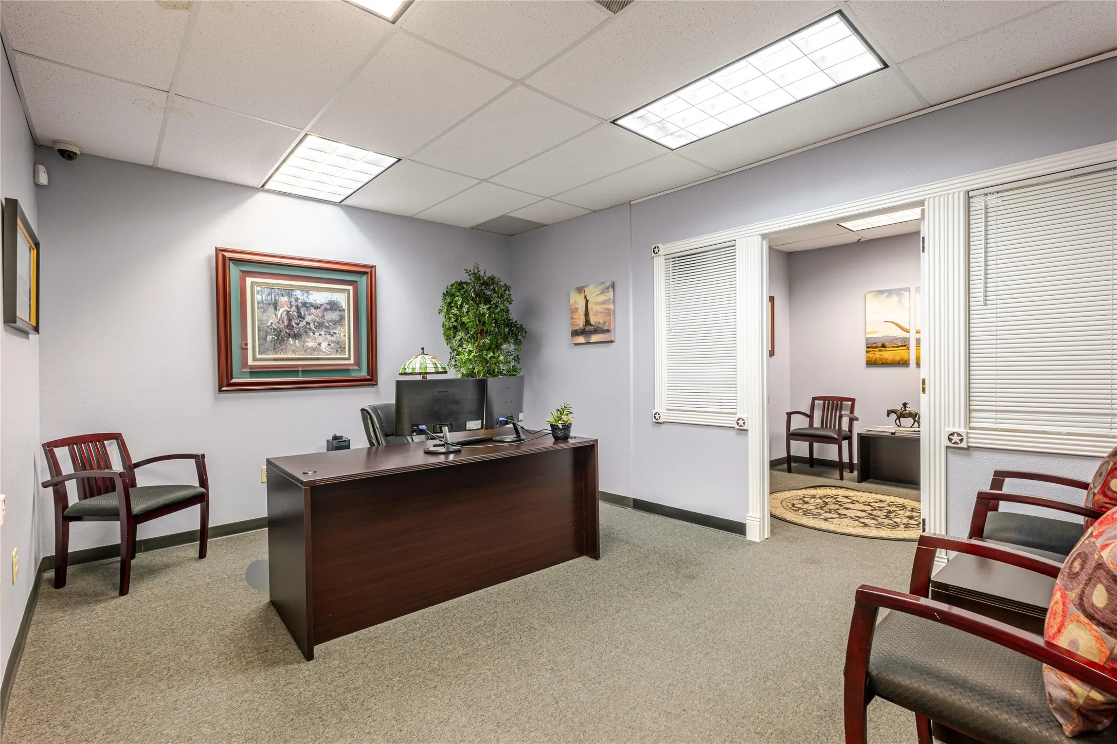 Commercial space featuring light gray walls, textured carpet flooring, and recessed ceiling lighting