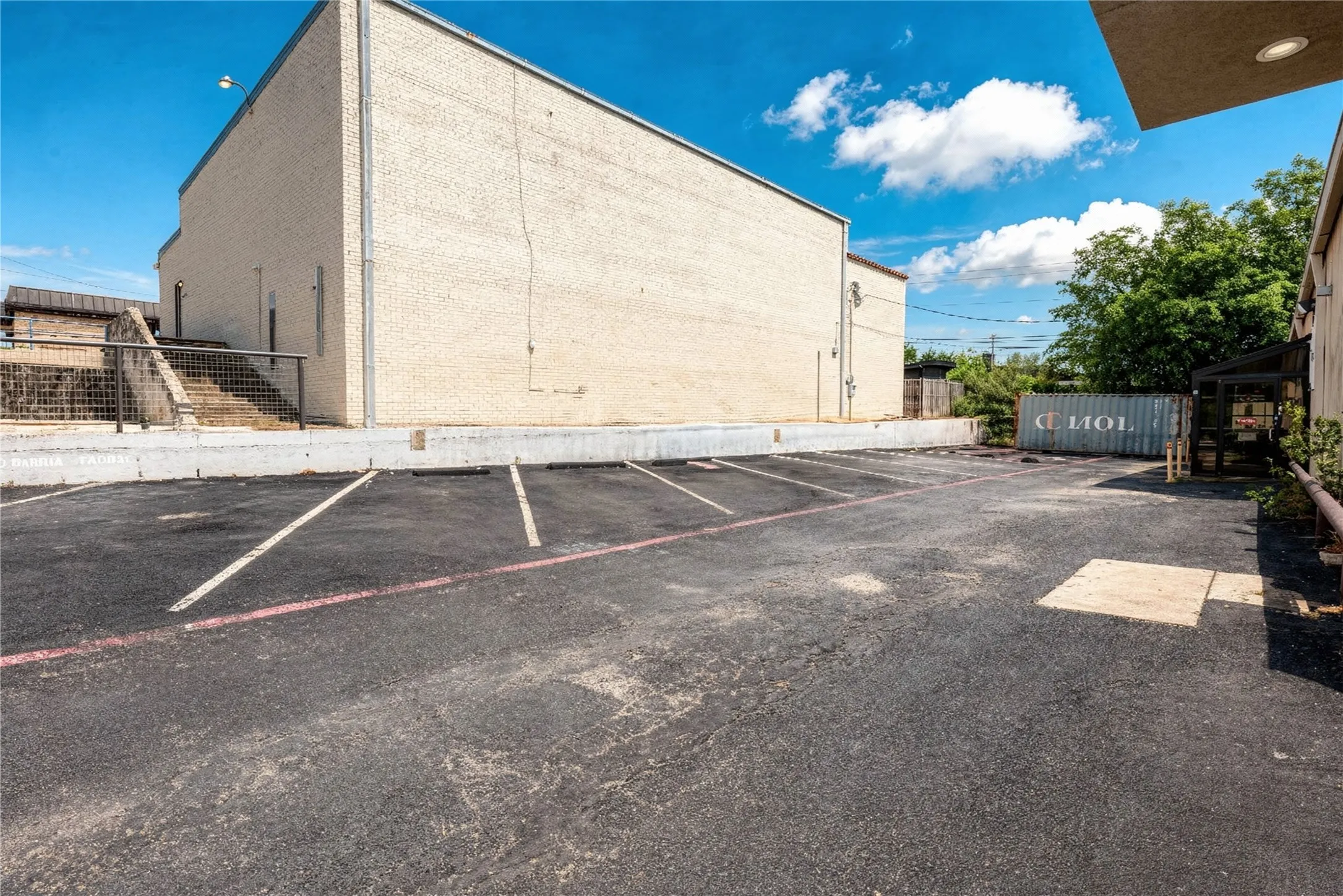 Asphalt parking area with multiple striped parking spaces