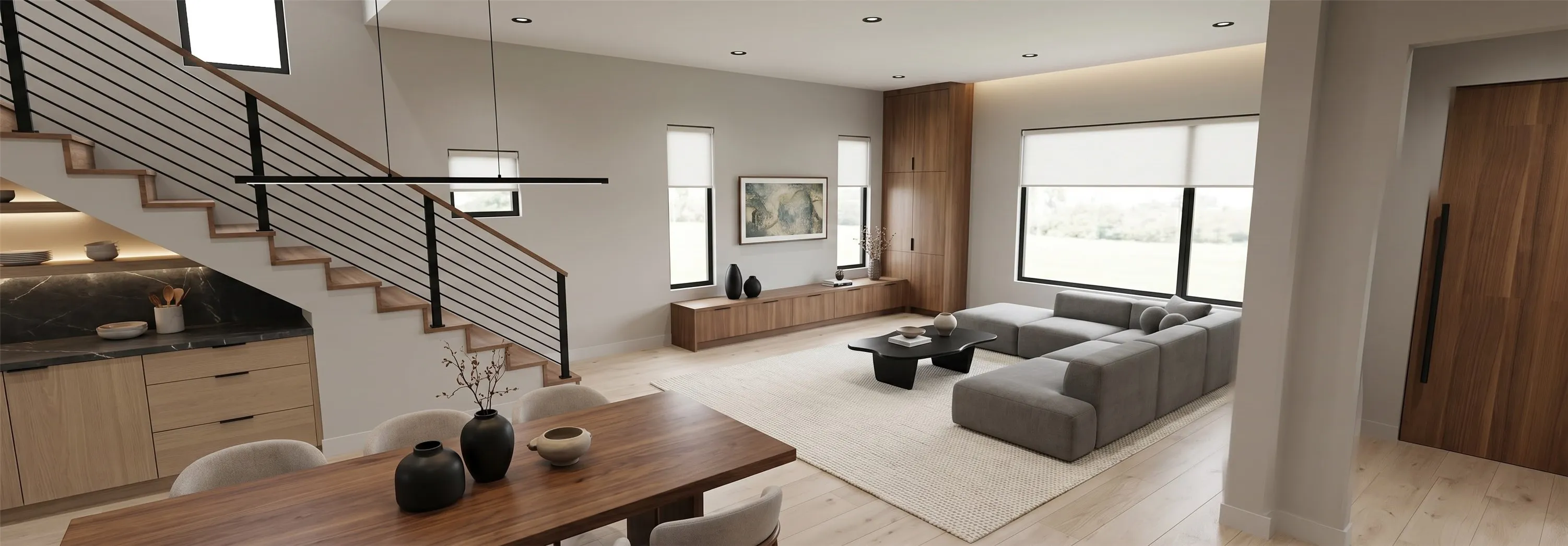 Open-concept living space featuring wood-finish flooring, a contemporary staircase with horizontal metal balusters, and a built-in media console