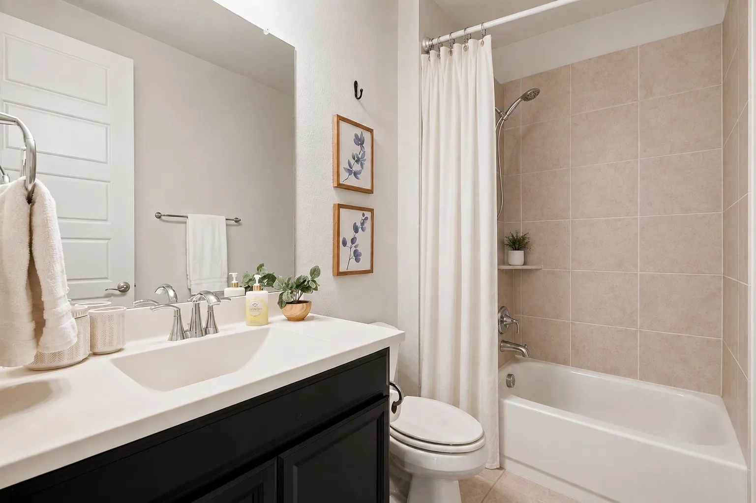 Bathroom featuring a built-in tub with tile surround, a single vanity with an integrated sink, and chrome fixtures