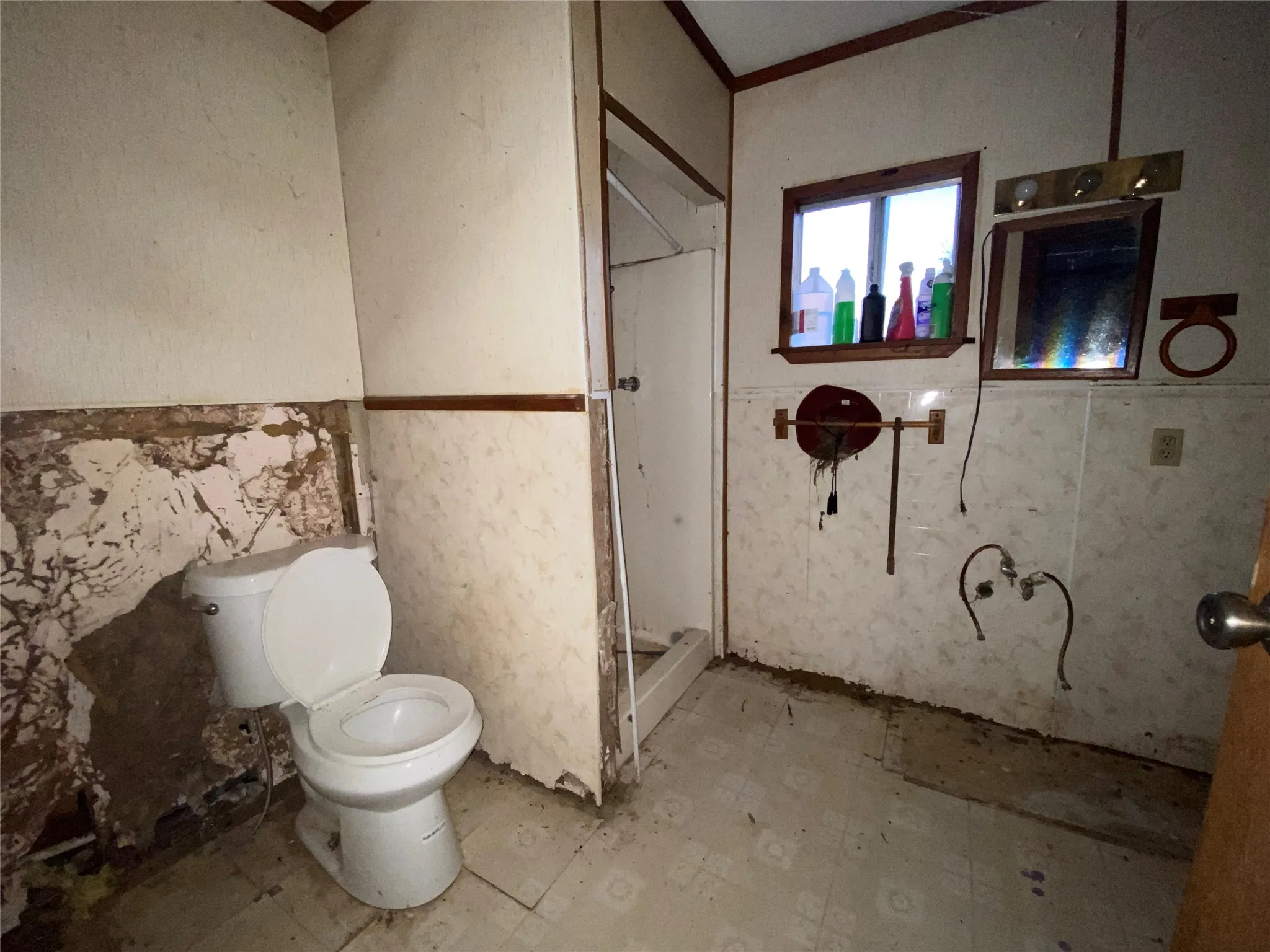 Bathroom with toilet, ornamental molding, and tile walls