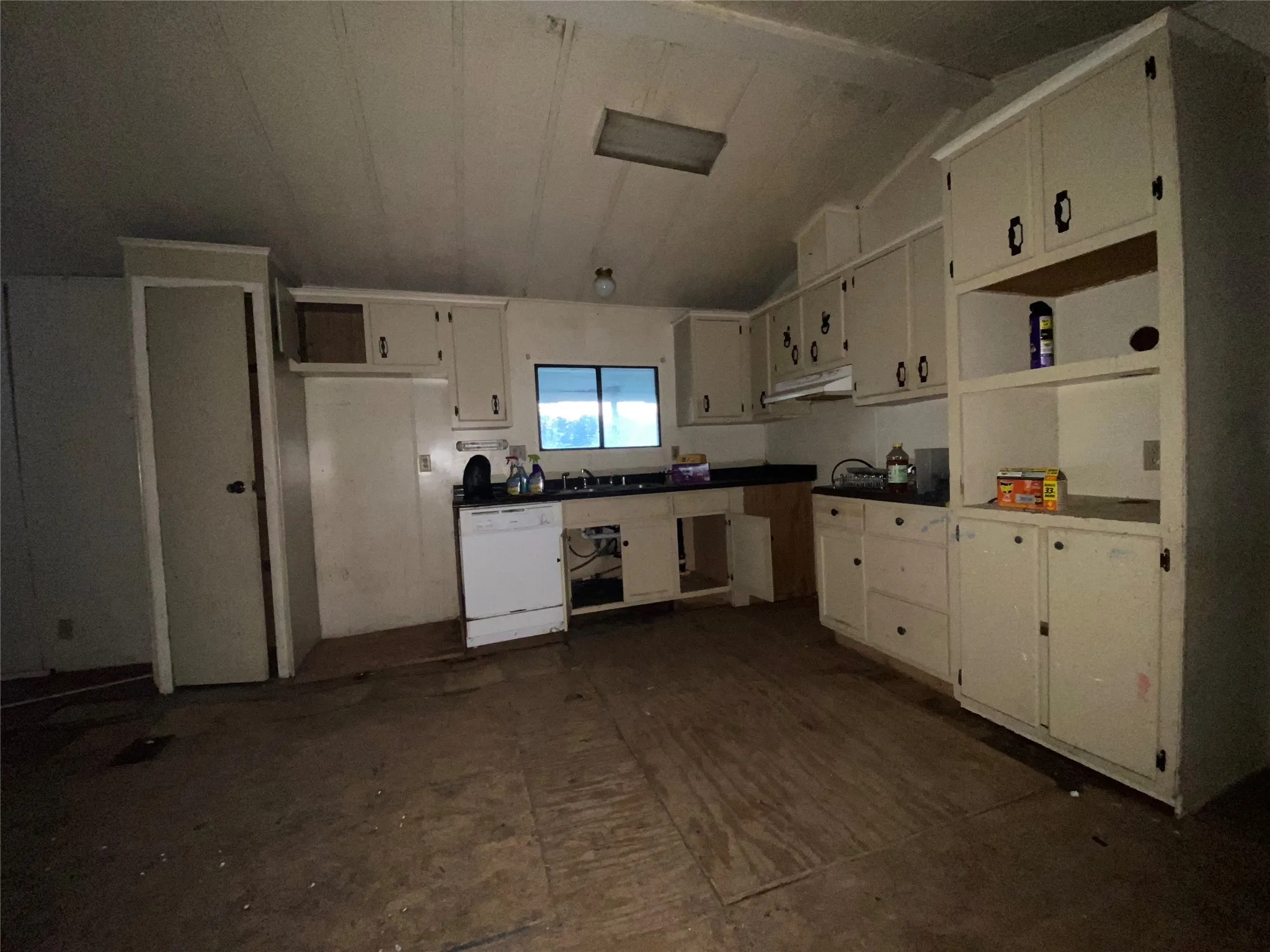 Kitchen featuring dishwasher and white cabinetry