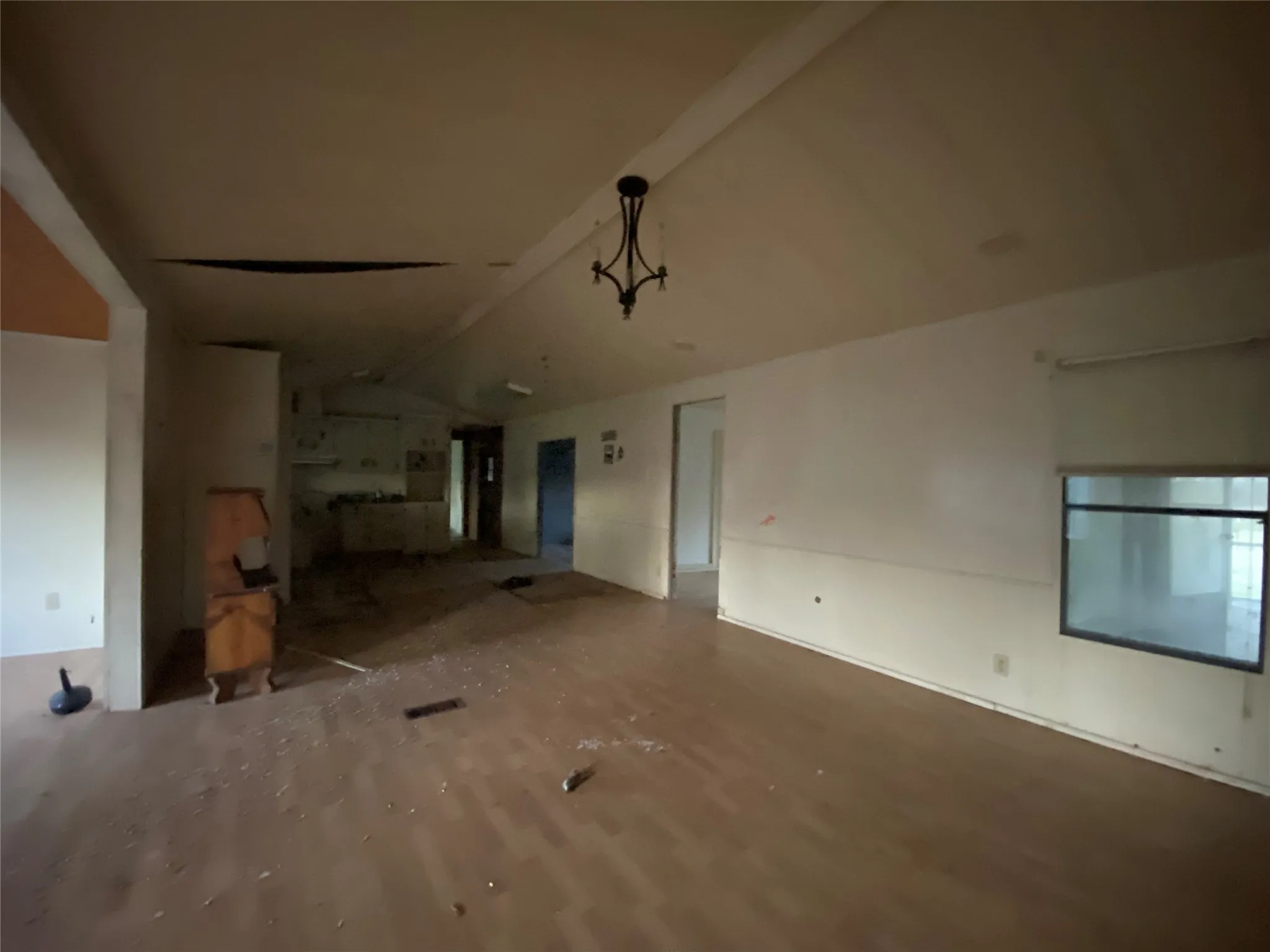 Unfurnished living room featuring lofted ceiling