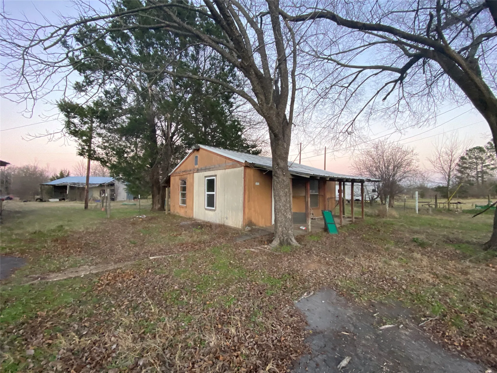 Yard at dusk featuring an outdoor structure