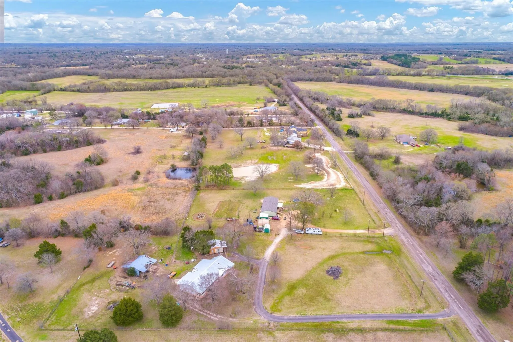 Birds eye view of property featuring a rural view