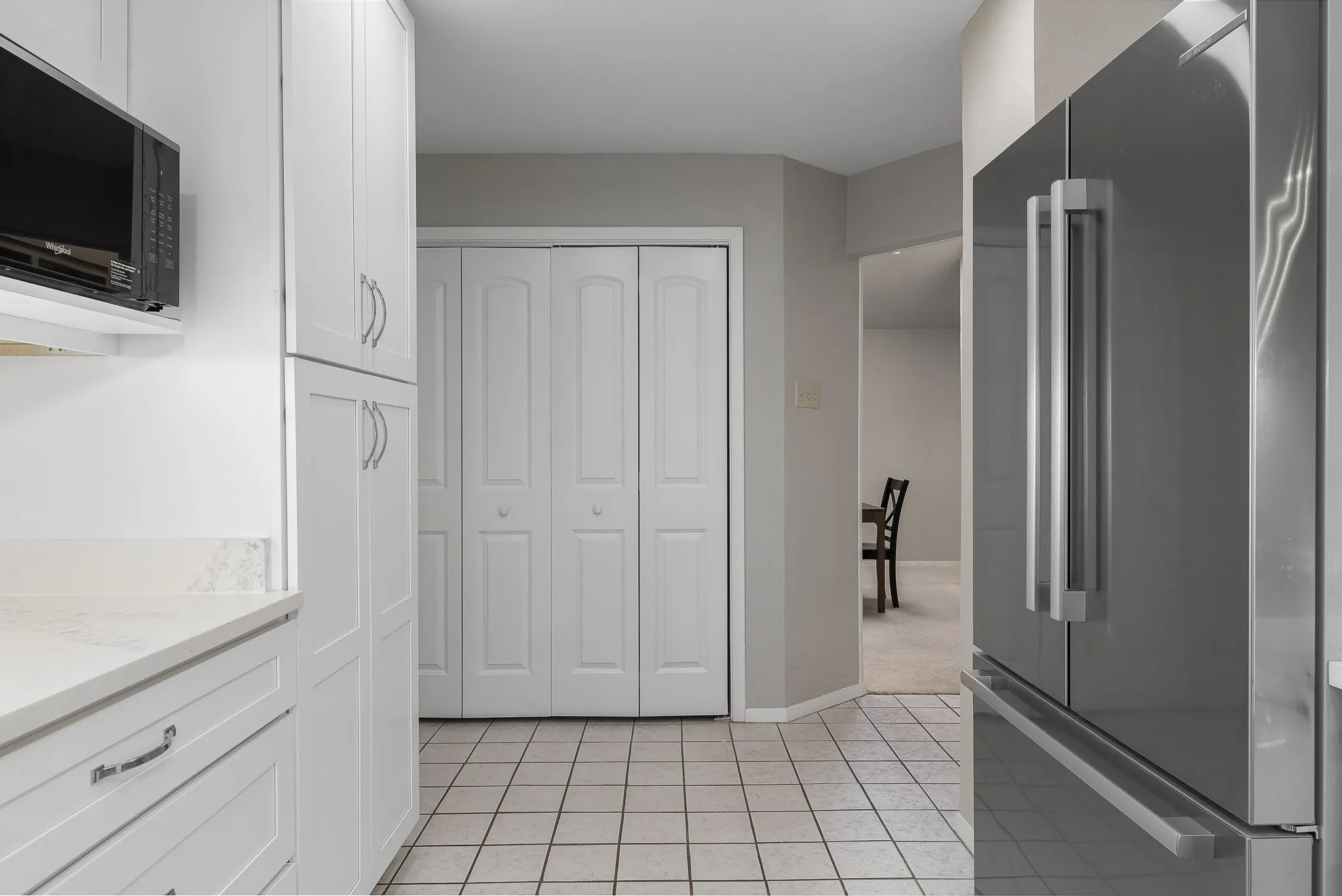 Fully updated kitchen — white cabinetry, granite counters, stainelss appliances.