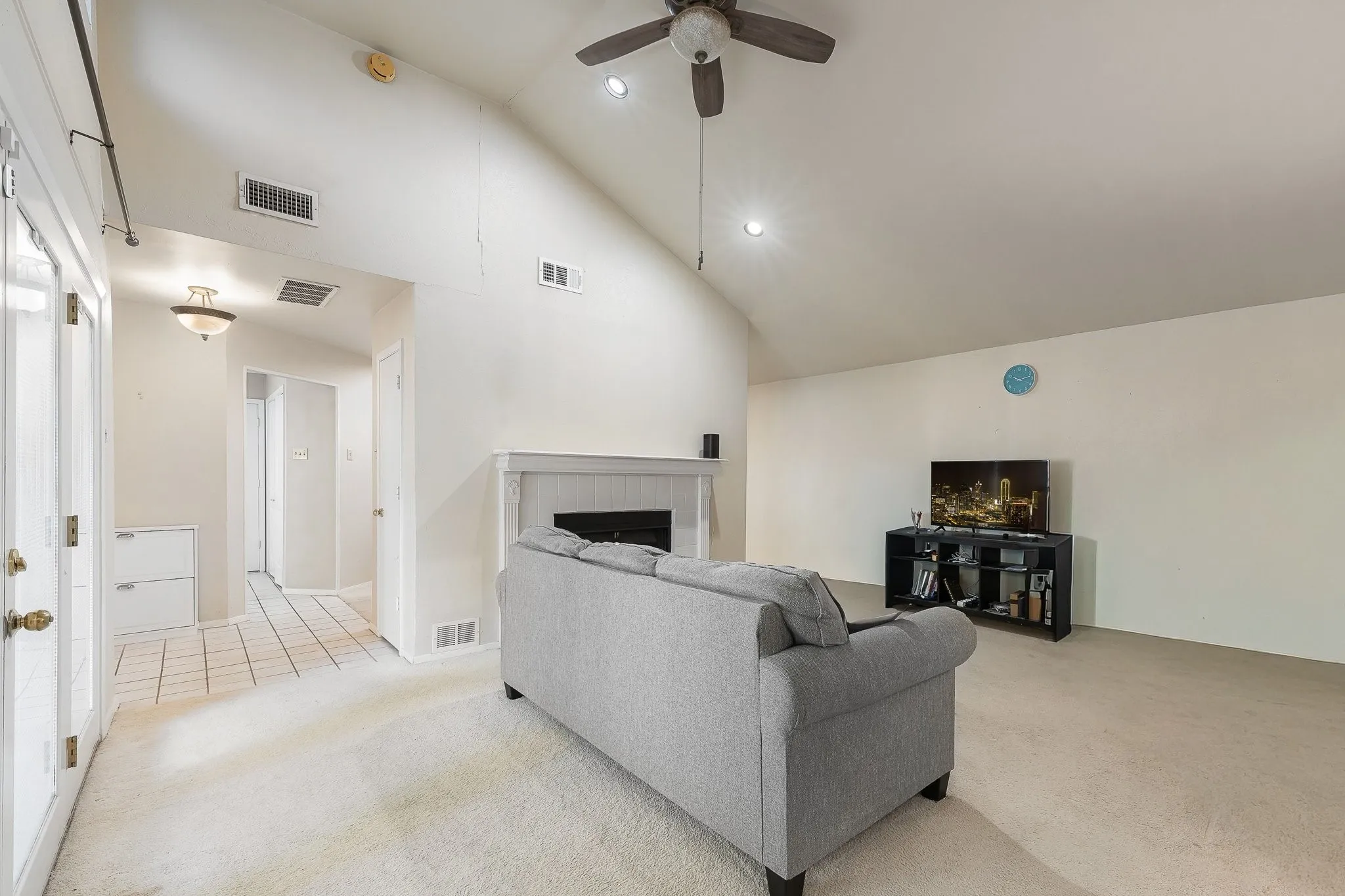 Spacious living room, vaulted ceilings, fireplace.