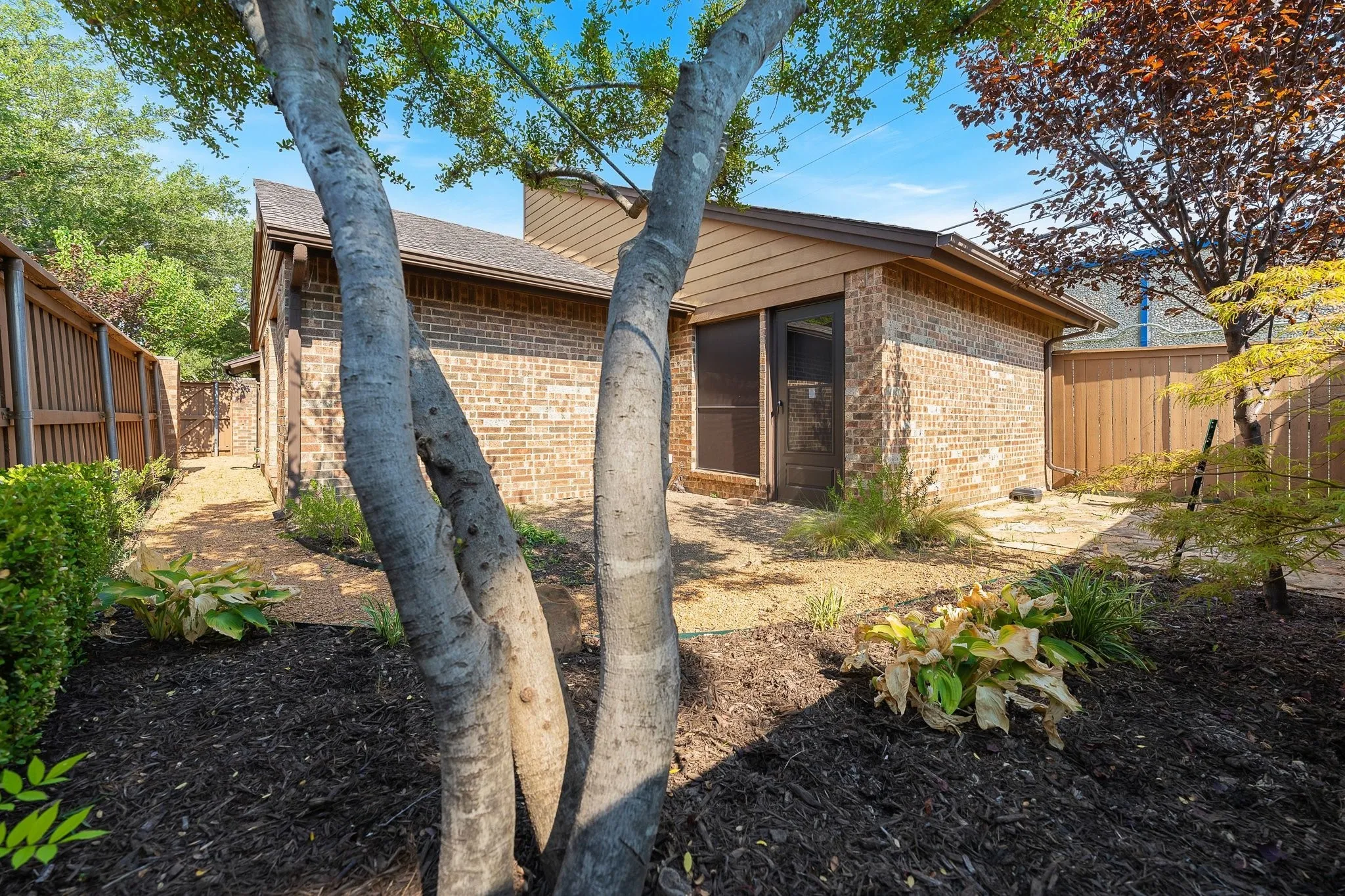 Xeriscaped side garden — low-maintenance beauty, private primary access.