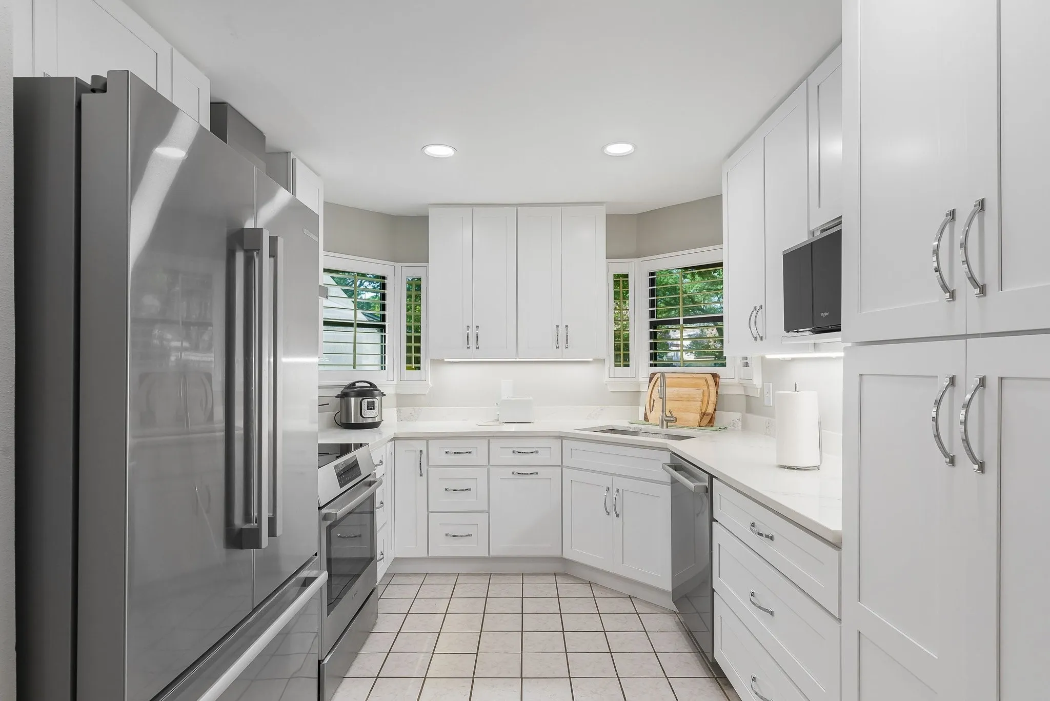 Fully updated kitchen — white cabinetry, granite counters, stainelss appliances.