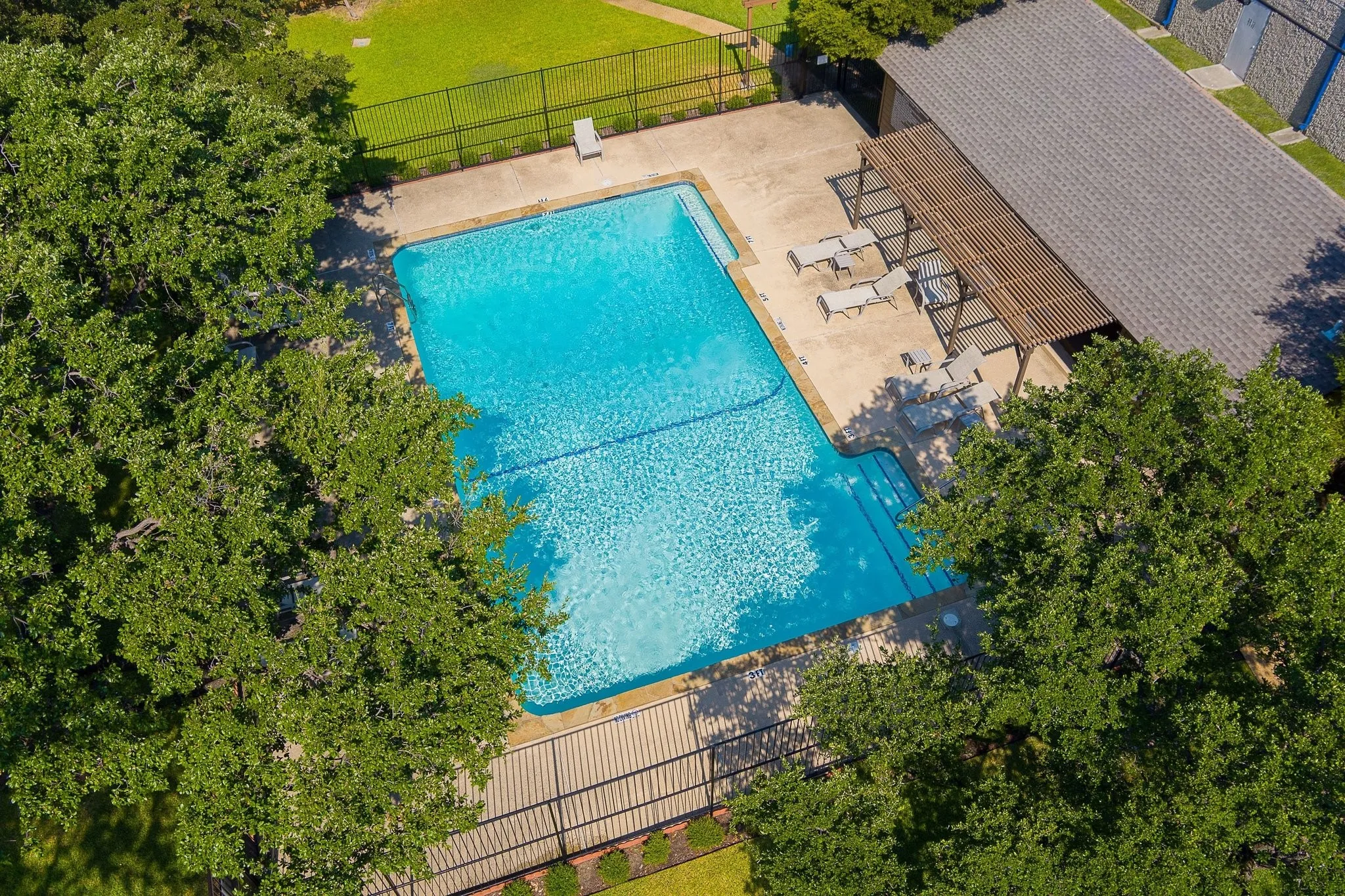 Community pool with pergola seating — resort-style, zero maintenance.