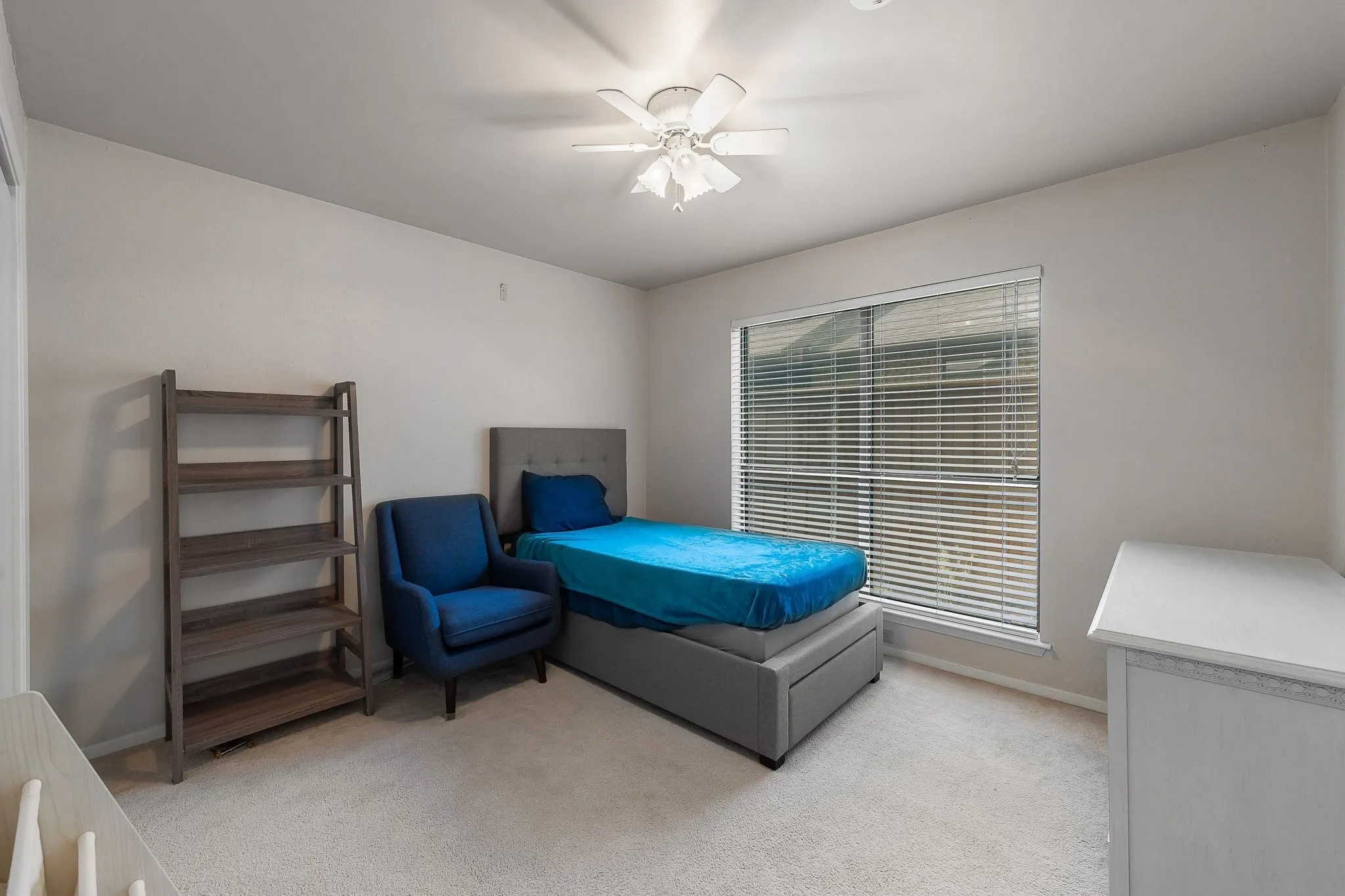 Sunny secondary bedroom offering flexible space and window light.