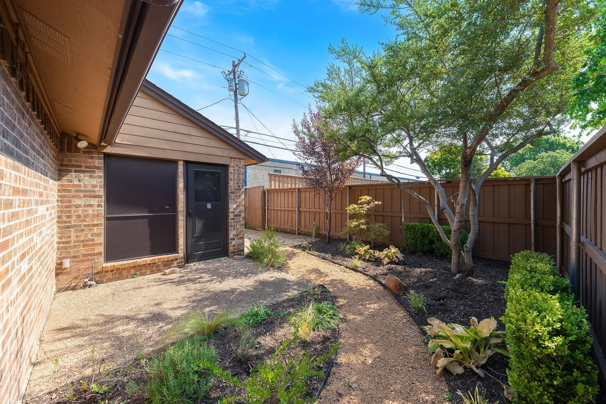 Xeriscaped side garden — low-maintenance beauty, private primary access.