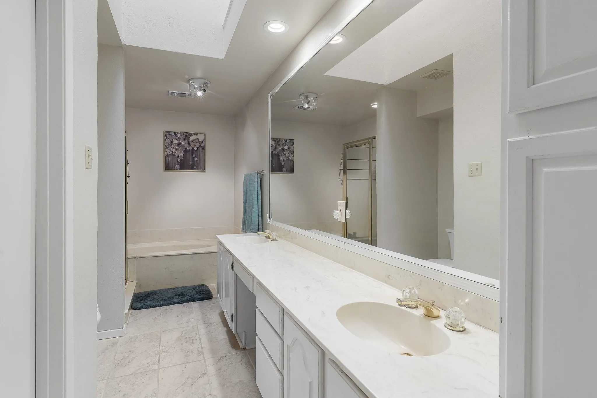 Primary bath with soaking tub and separate shower.