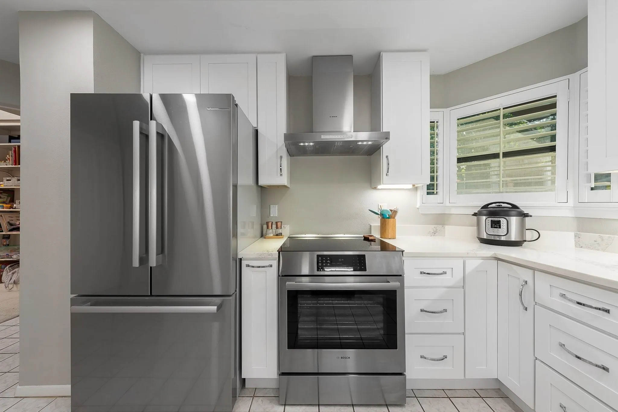 Fully updated kitchen — white cabinetry, granite counters, stainelss appliances.