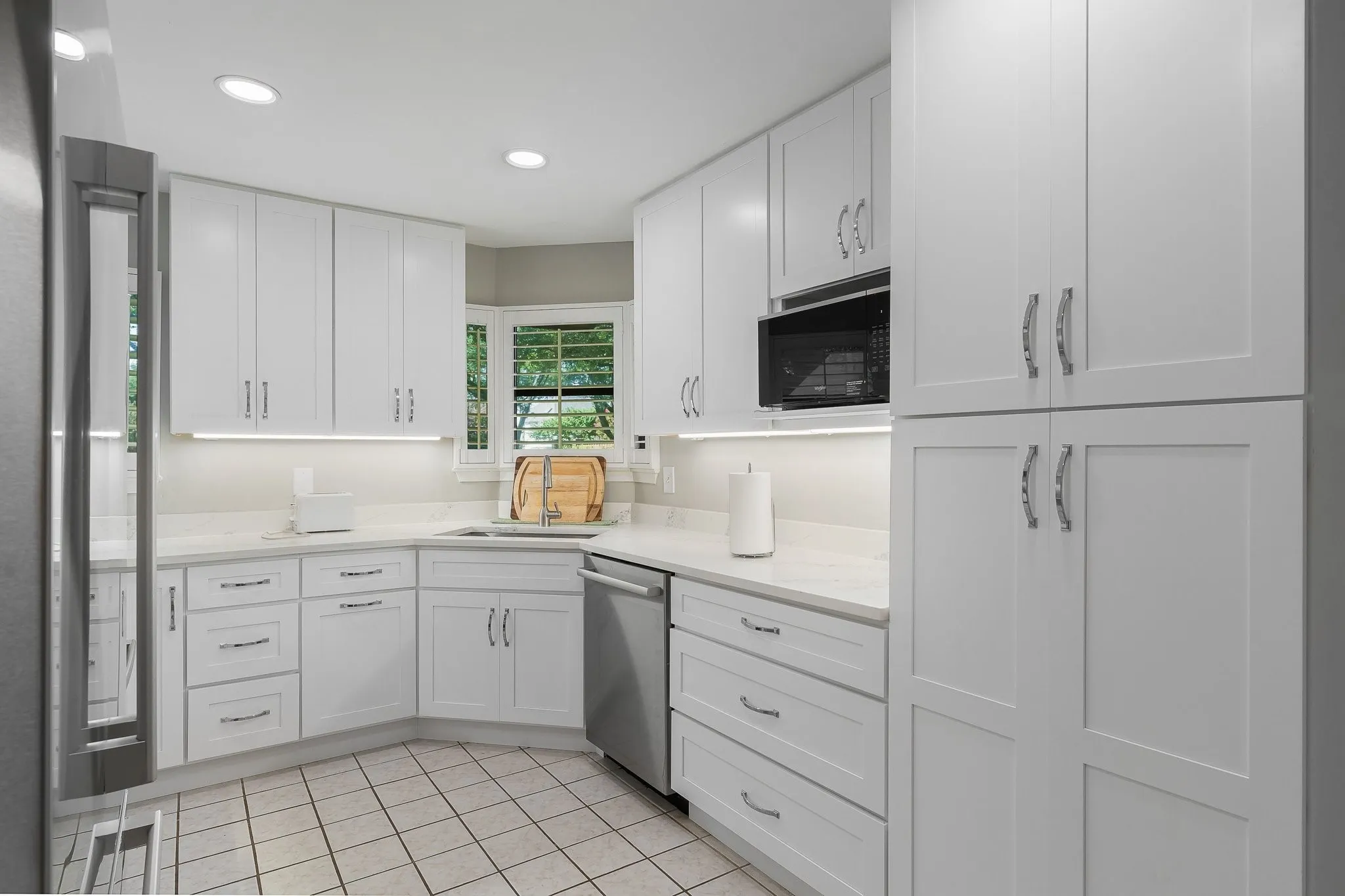 Fully updated kitchen — white cabinetry, granite counters, stainelss appliances.
