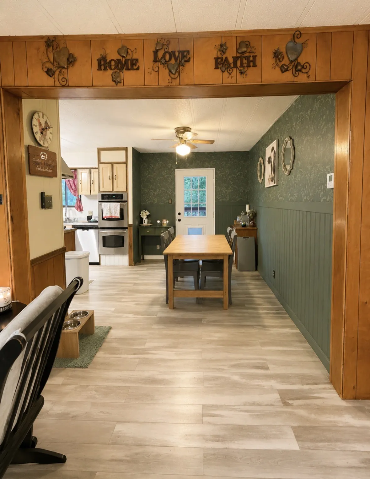 Expansive interior featuring wood-finish flooring, wood paneling, and a ceiling fan