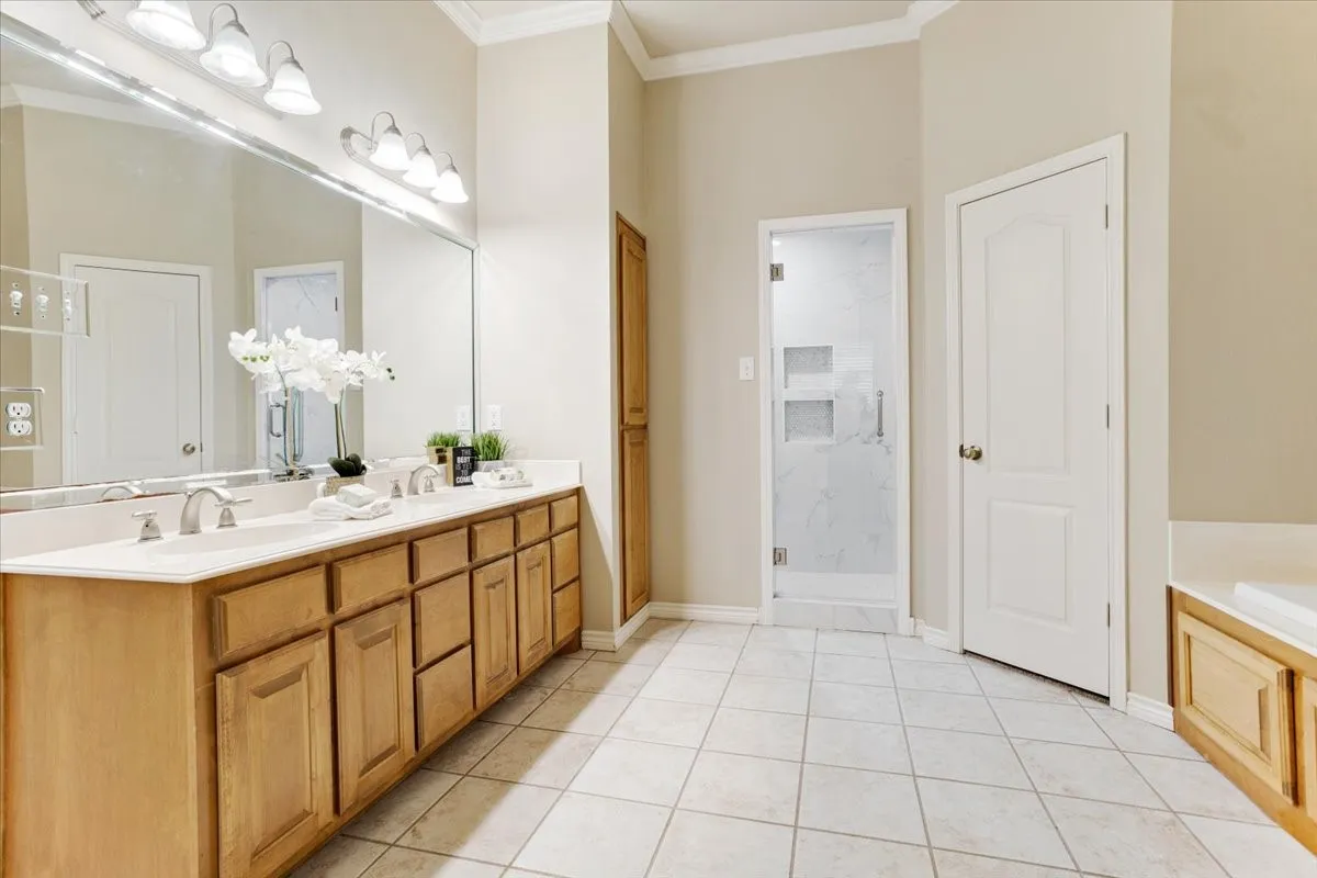 Double sinks so you don't have to share! Door to the right is one of the walk in closets!