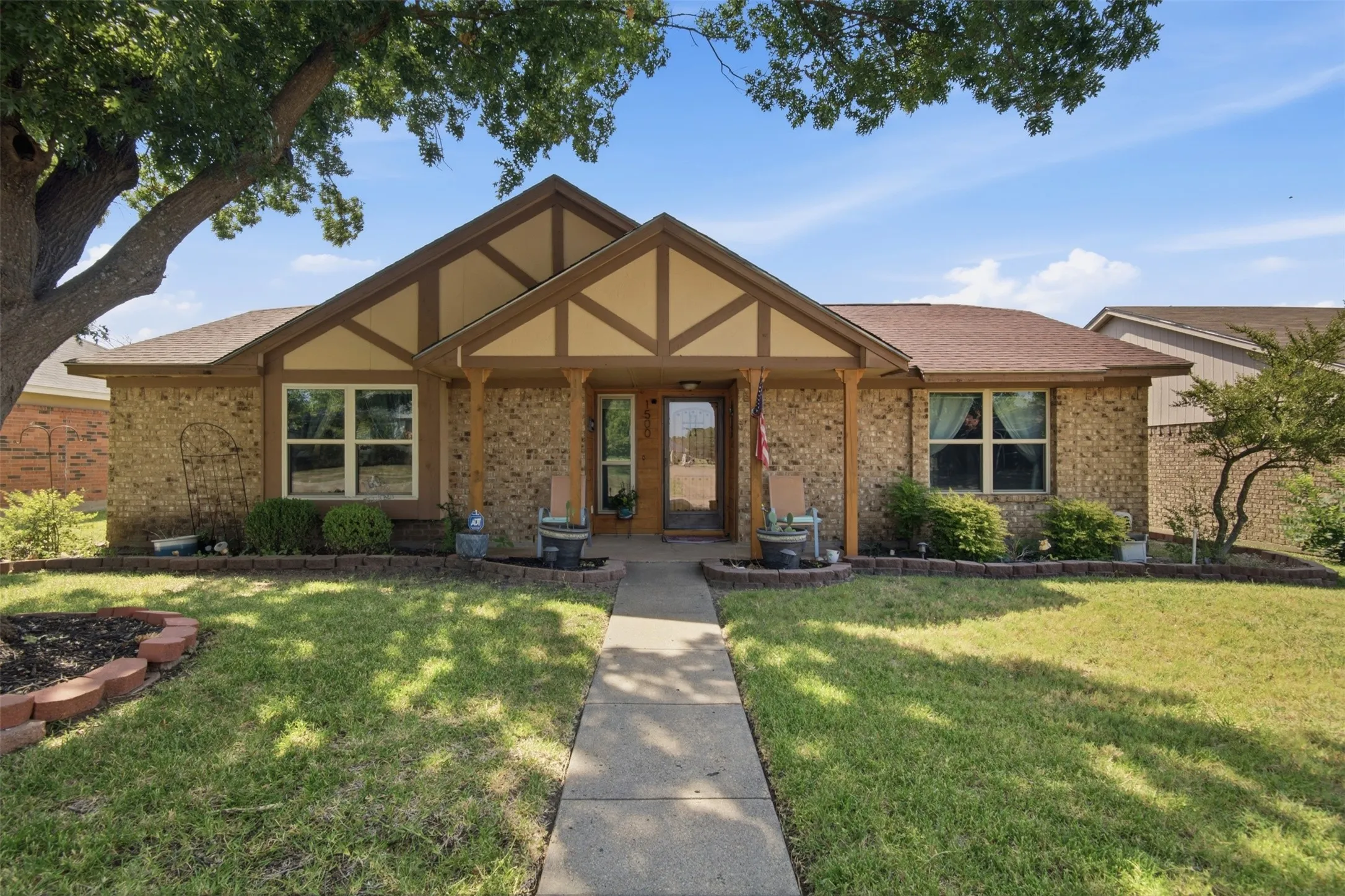 Charming brick exterior with a prominent front gable featuring decorative timber accents