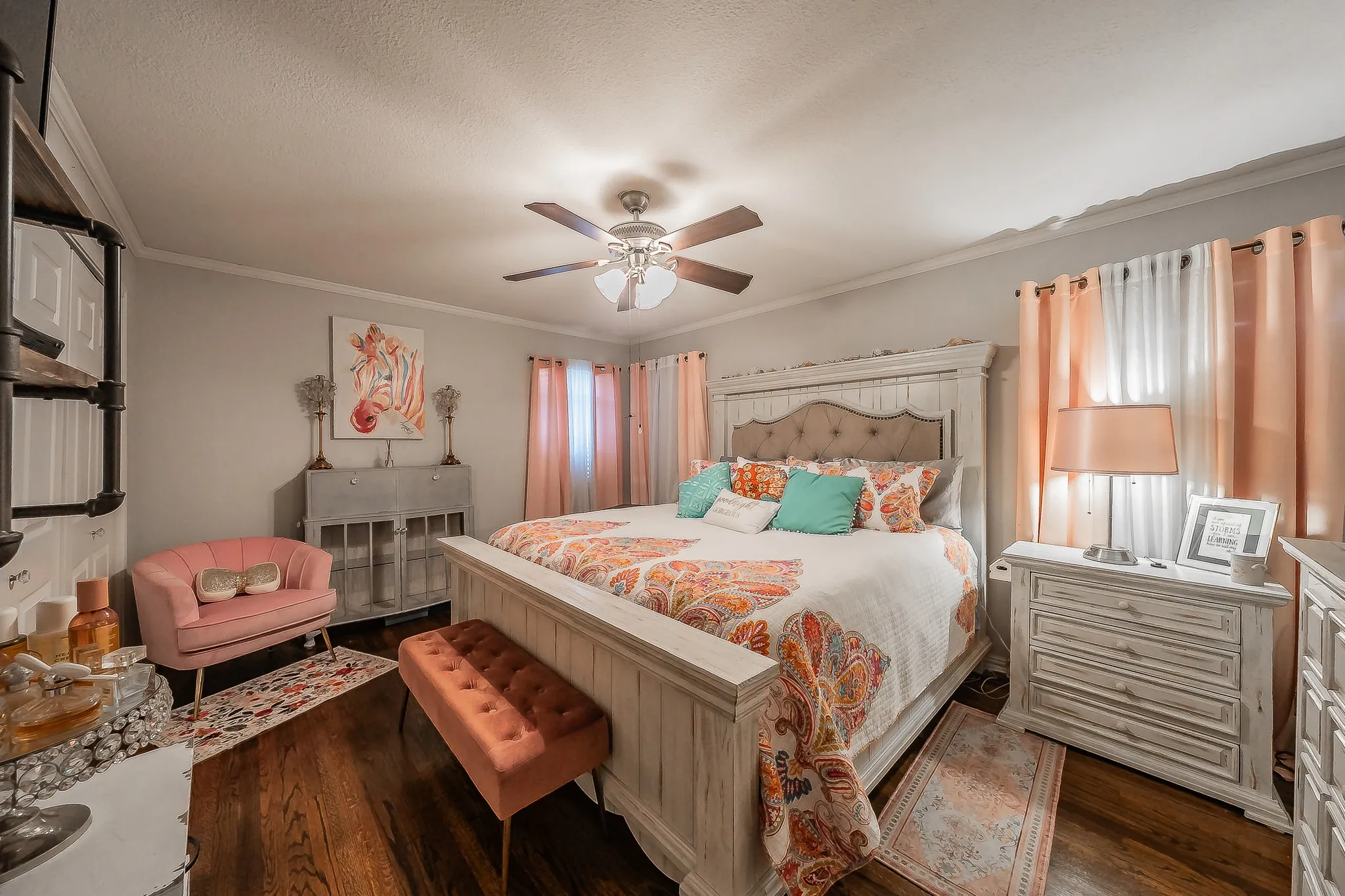 Hardwood flooring highlighting a built-in shelving unit, crown molding, and a ceiling fan with integrated lighting