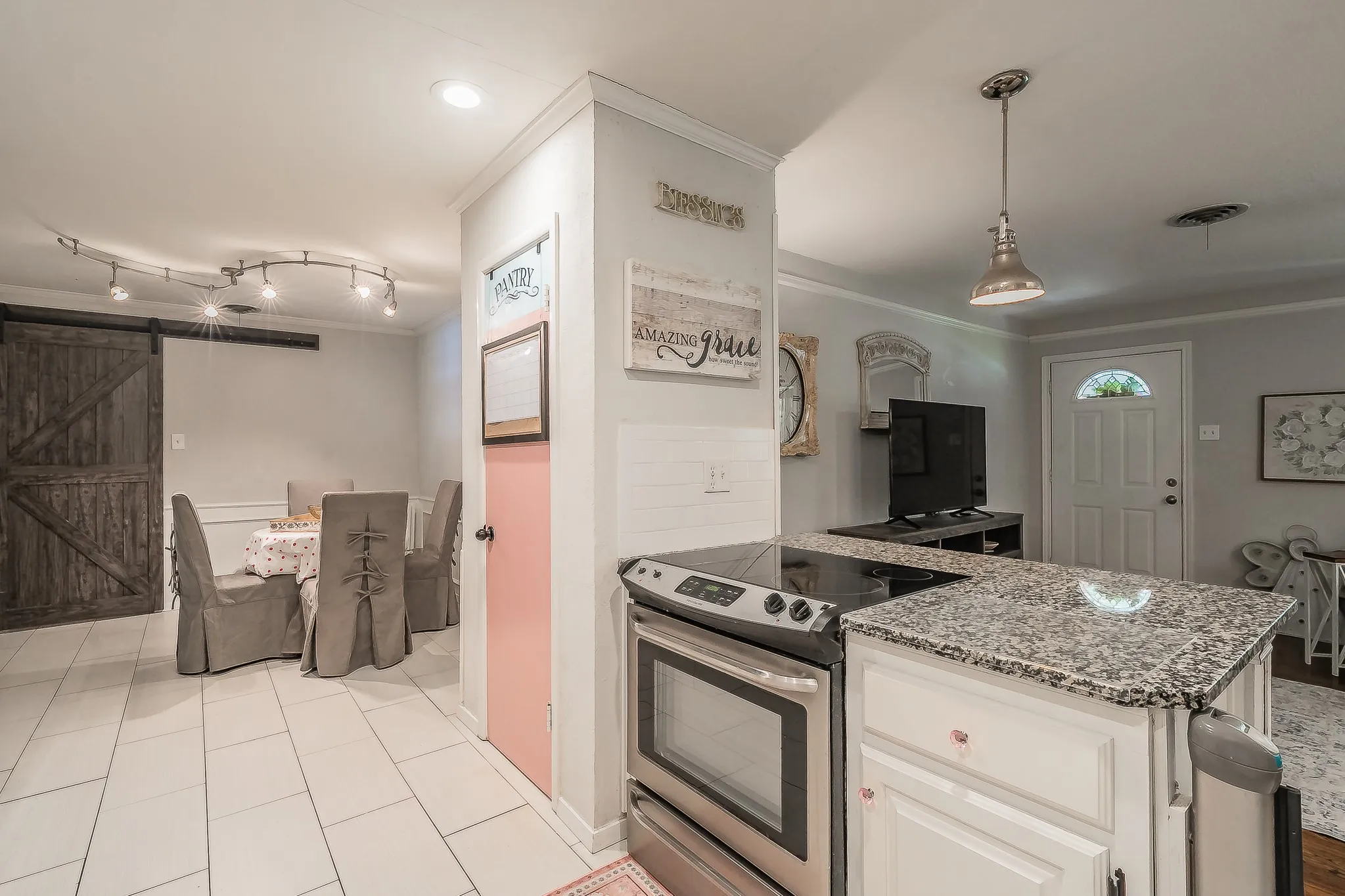 Kitchen island with a granite countertop and stainless steel range