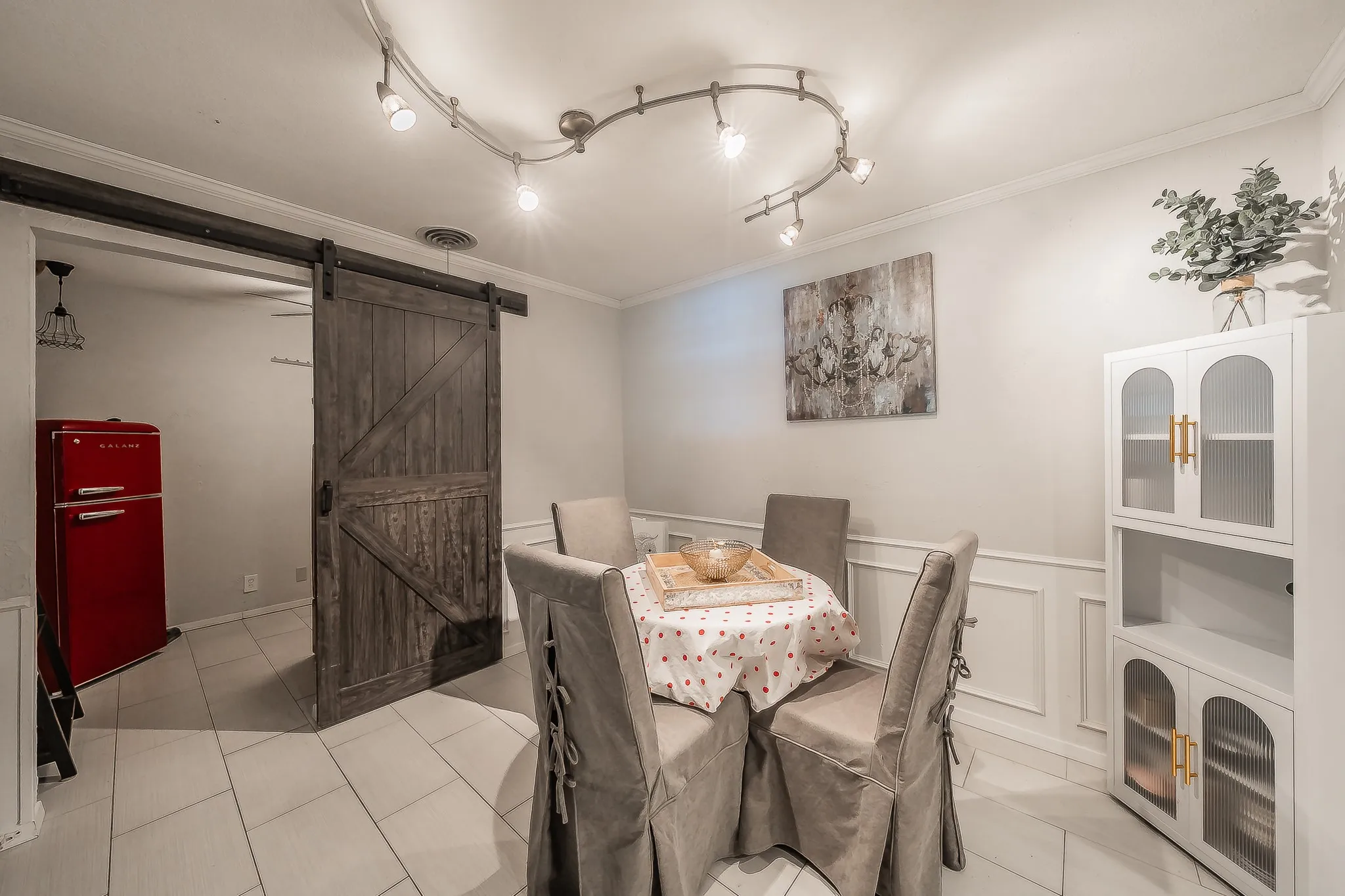 Dining area featuring a rustic wood barn door