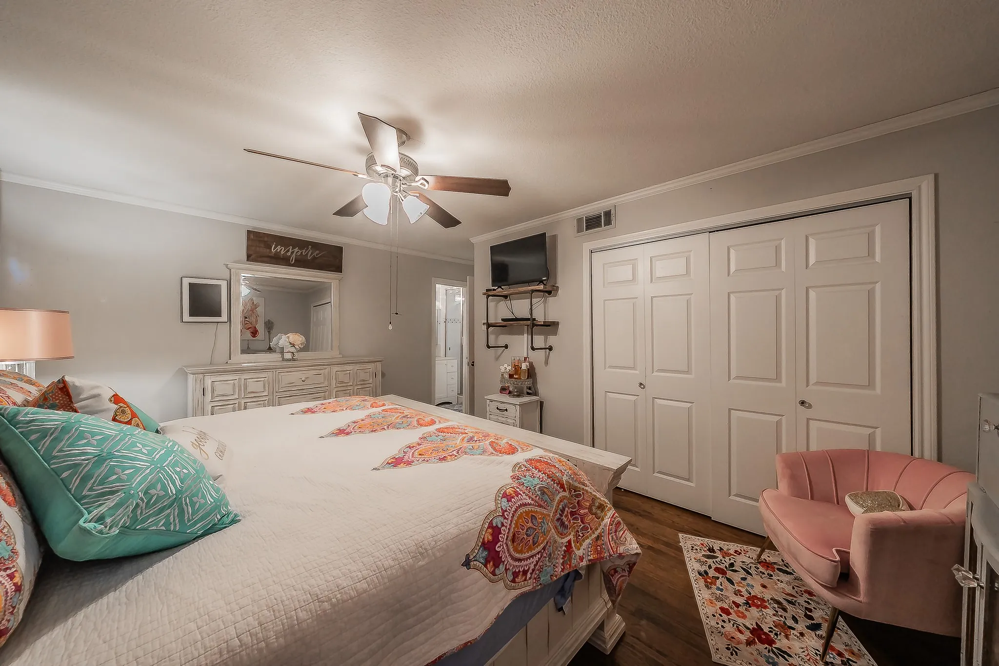Hardwood-look flooring complemented by light-toned wall paint and white crown molding