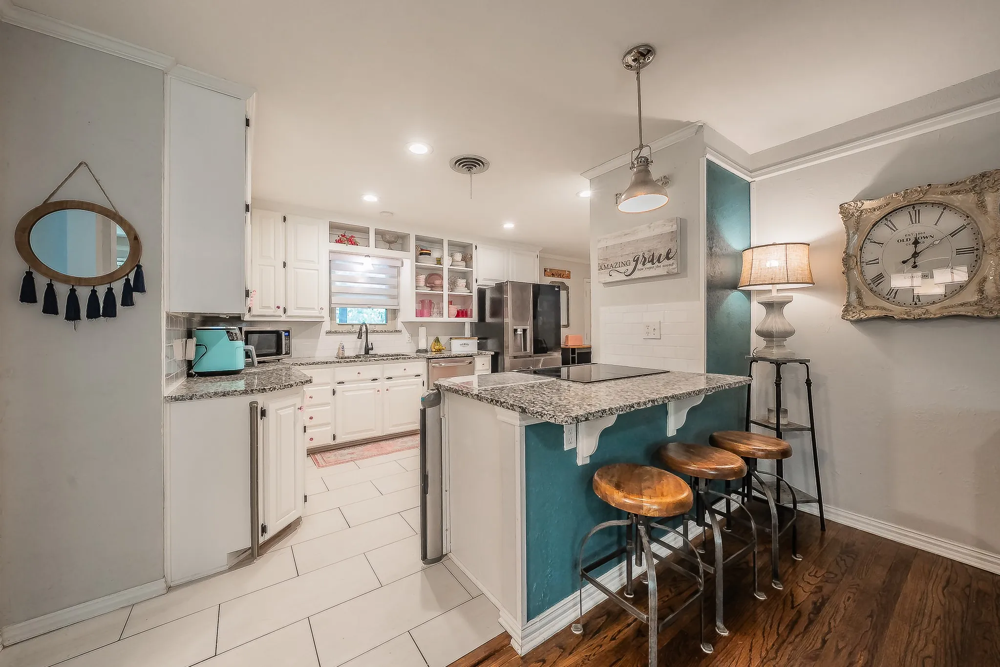 Kitchen with white cabinetry, granite countertops, and recessed lighting