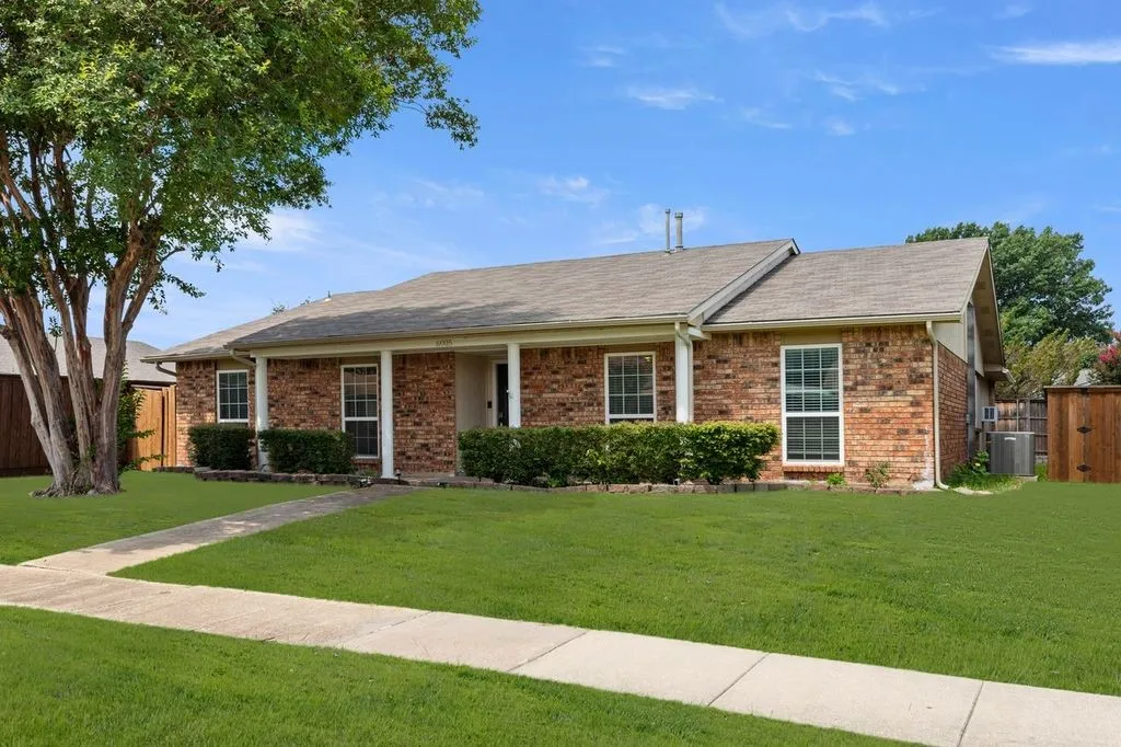 Brick exterior with a gabled roof and covered entry