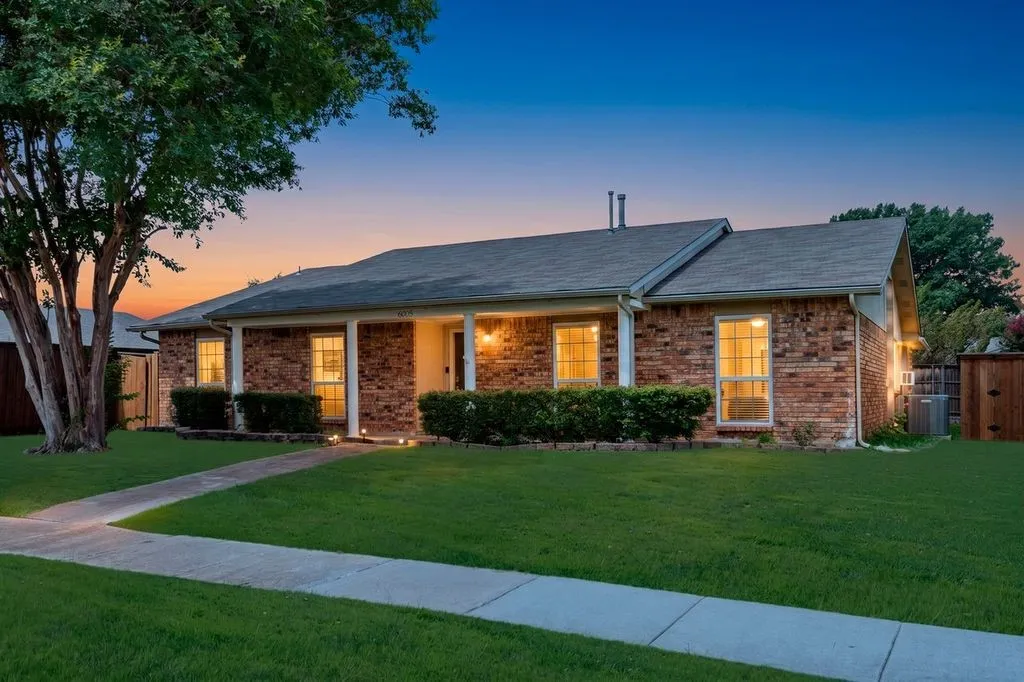 Brick exterior with a covered front porch featuring white columns