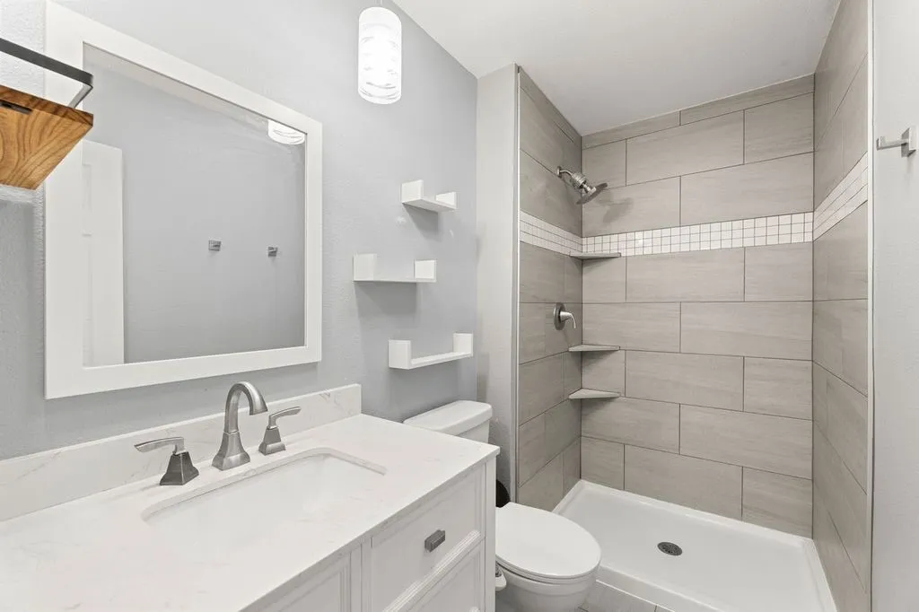 Contemporary bathroom featuring a vanity with a white countertop and undermount sink