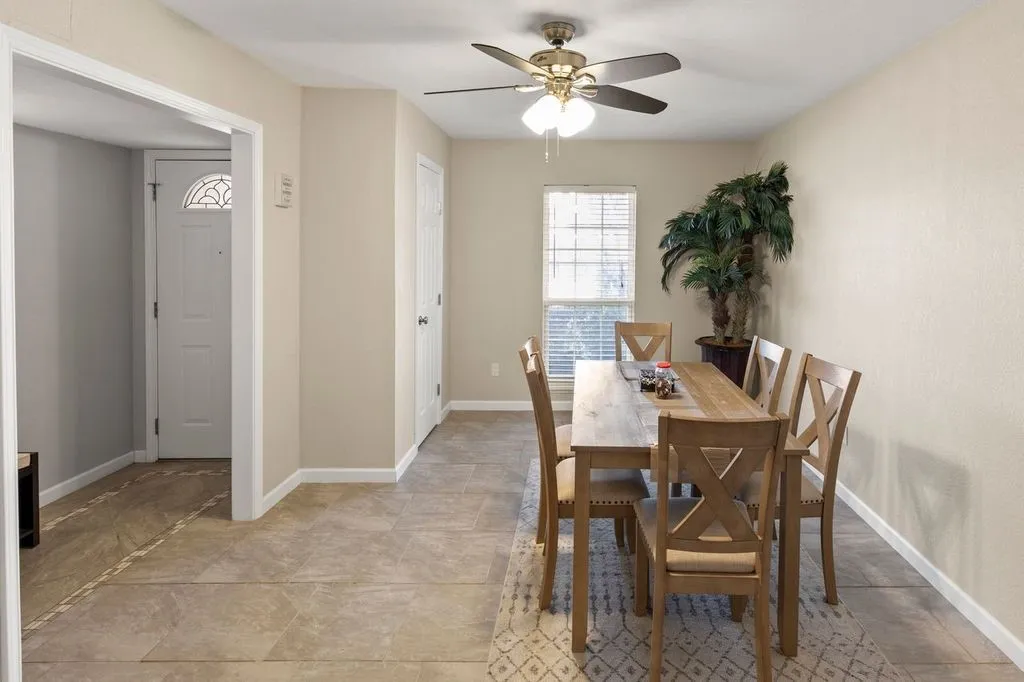 Dining area featuring tile flooring, a window with blinds, and neutral wall paint