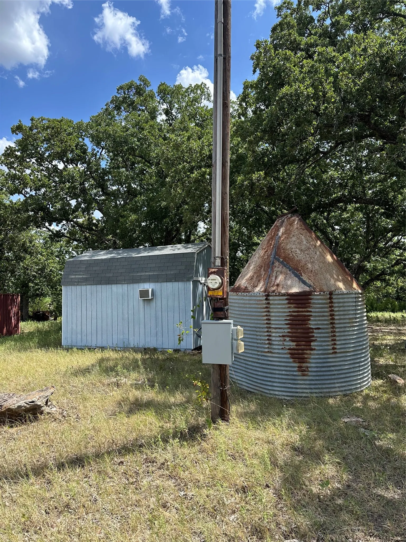 Electric pole/meter and water well.
