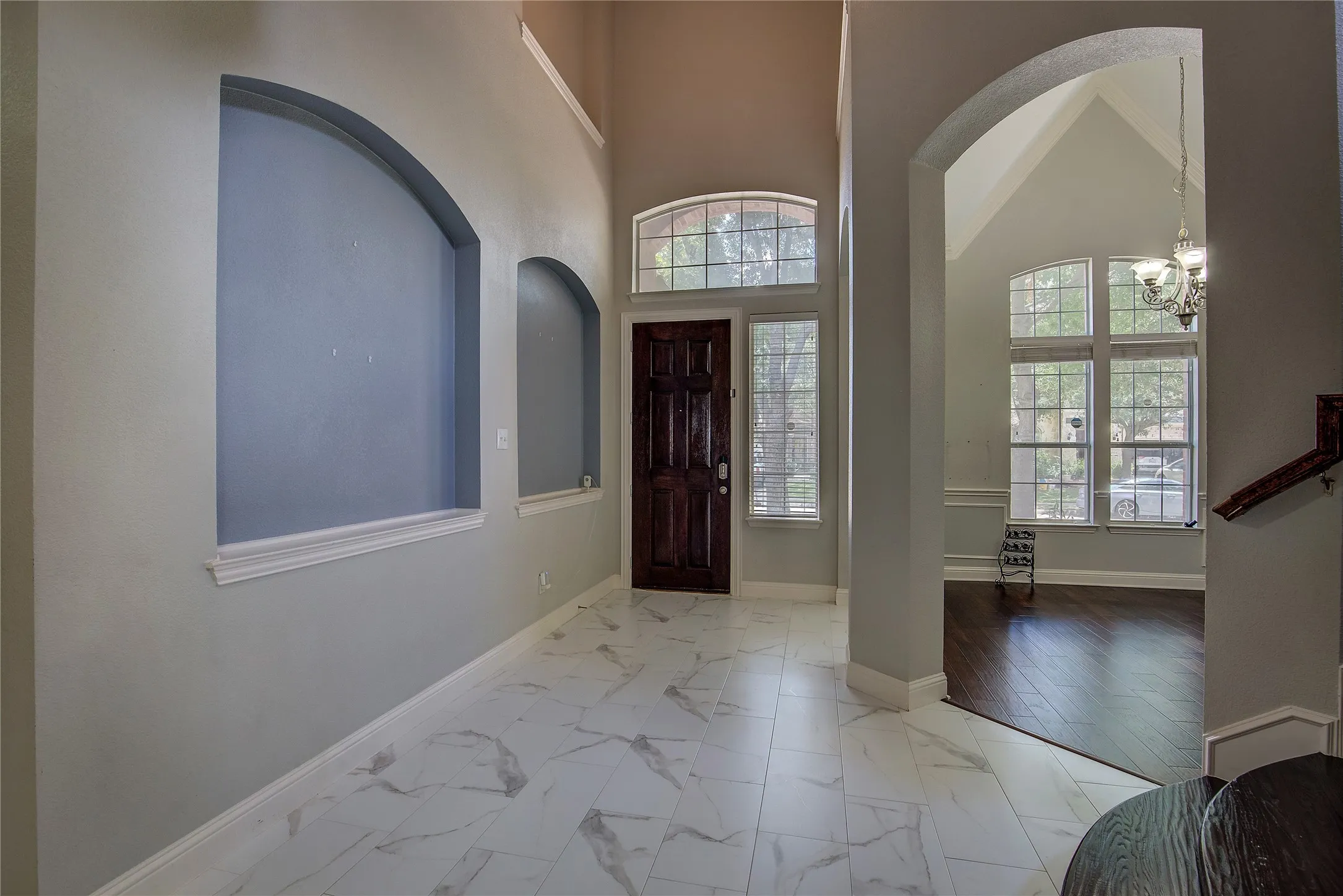 Foyer entrance featuring light tile patterned flooring, a towering ceiling, and a​​‌​​​​‌​​‌‌​‌‌​​​‌‌​‌​‌​‌​​​‌​​ chandelier