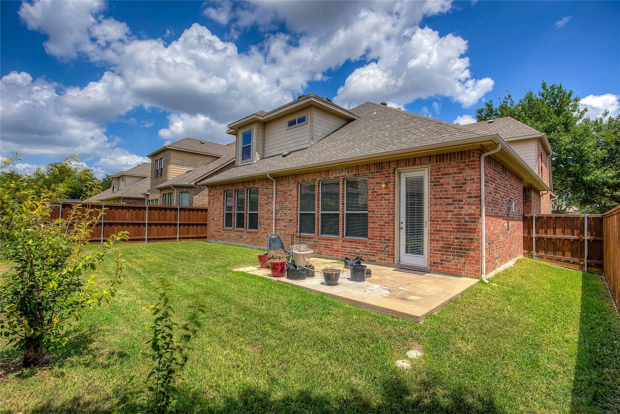 Back of house featuring a patio and a yard