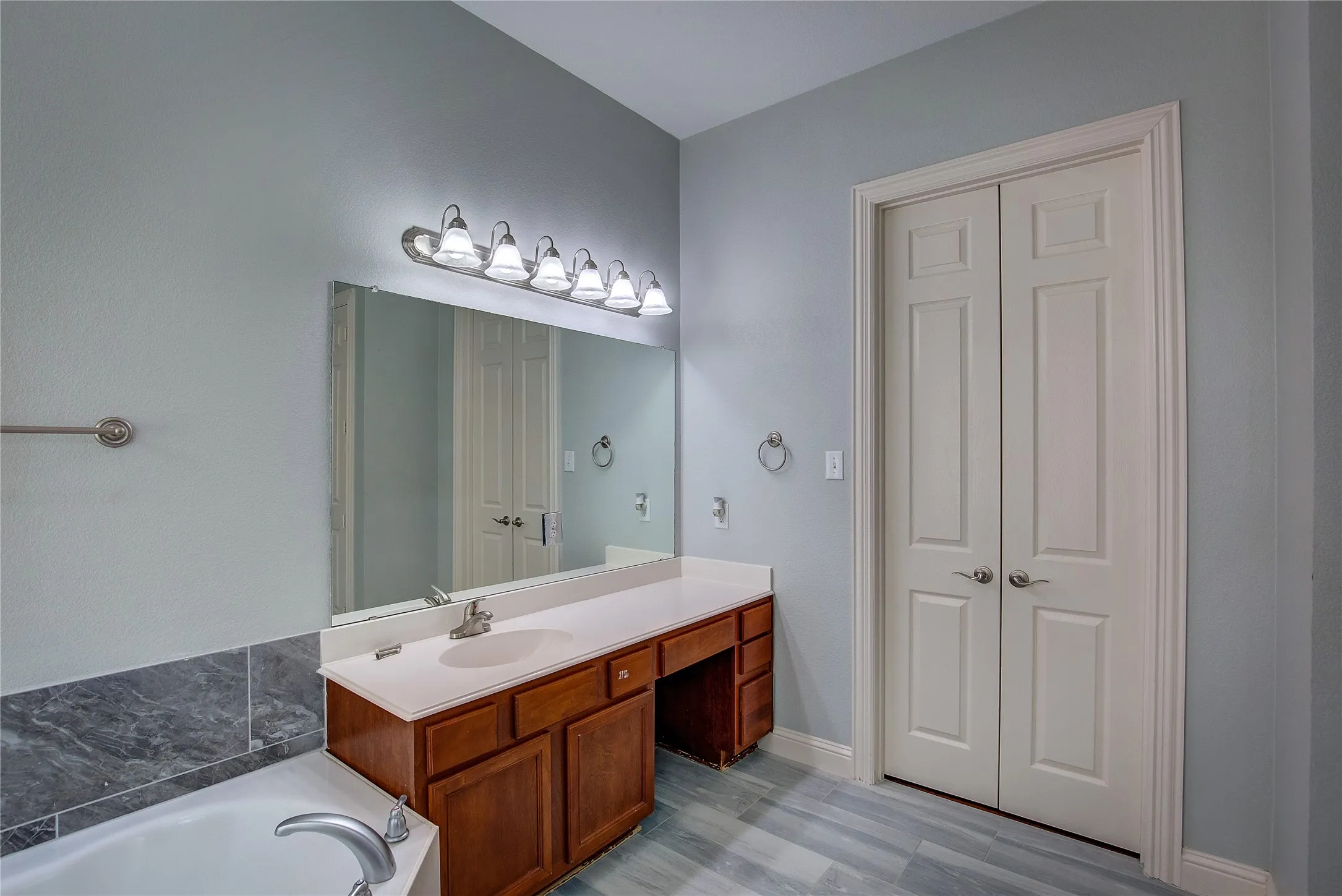 Bathroom with vanity and a tub to relax in