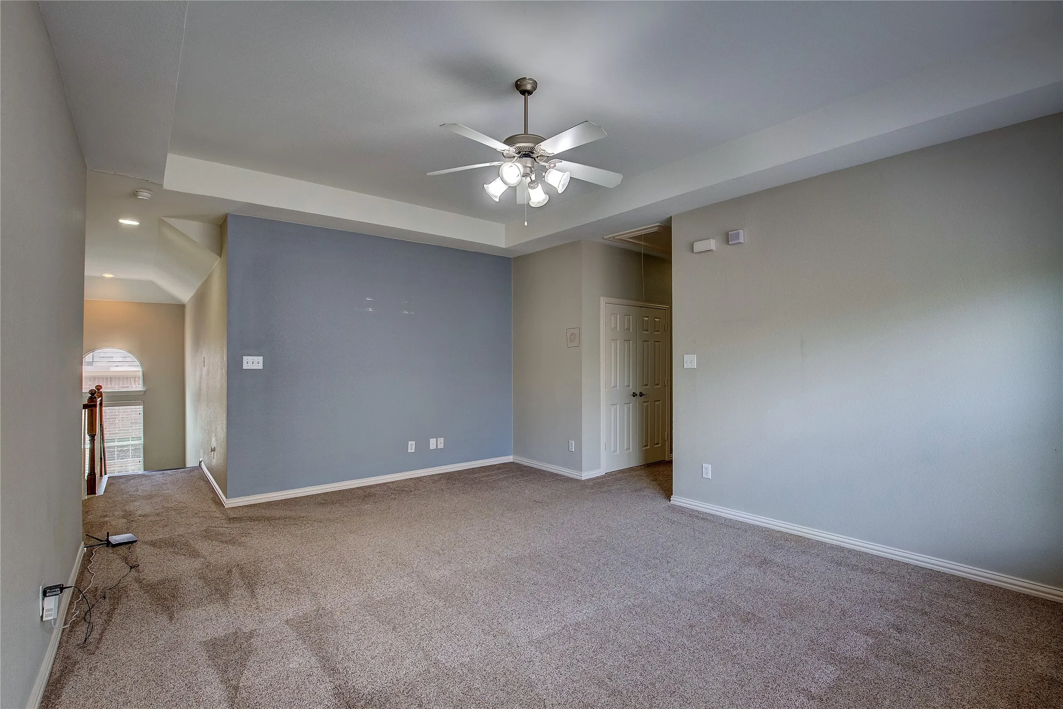 Unfurnished room with lofted ceiling, light carpet, and ceiling fan