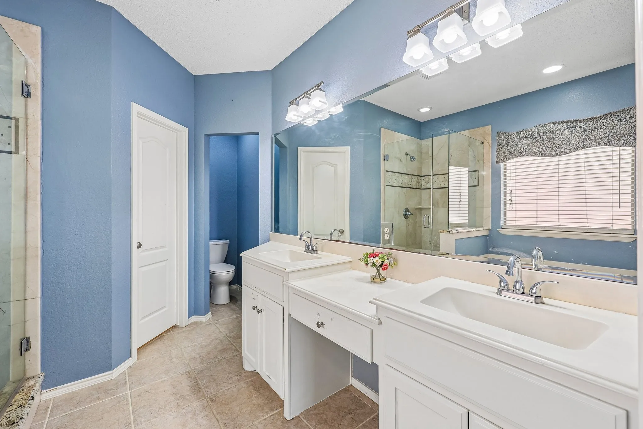 Dual vanity with white cabinetry and integrated sinks